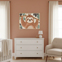 Modern nursery with a terracotta wall. A light wood framed illustration of a happy cartoon sloth hanging from a branch with leaves is centered above a white dresser. A white crib is on the left and a beige armchair is on the right.