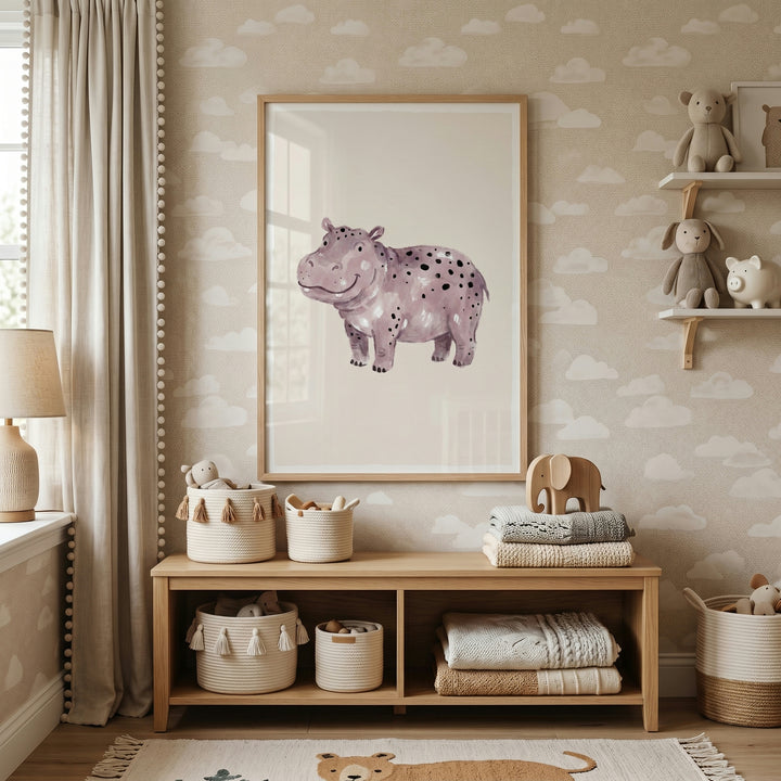 Neutral nursery with cloud wallpaper and a smiling black spotted hippo artwork above a wooden shelf with woven baskets.