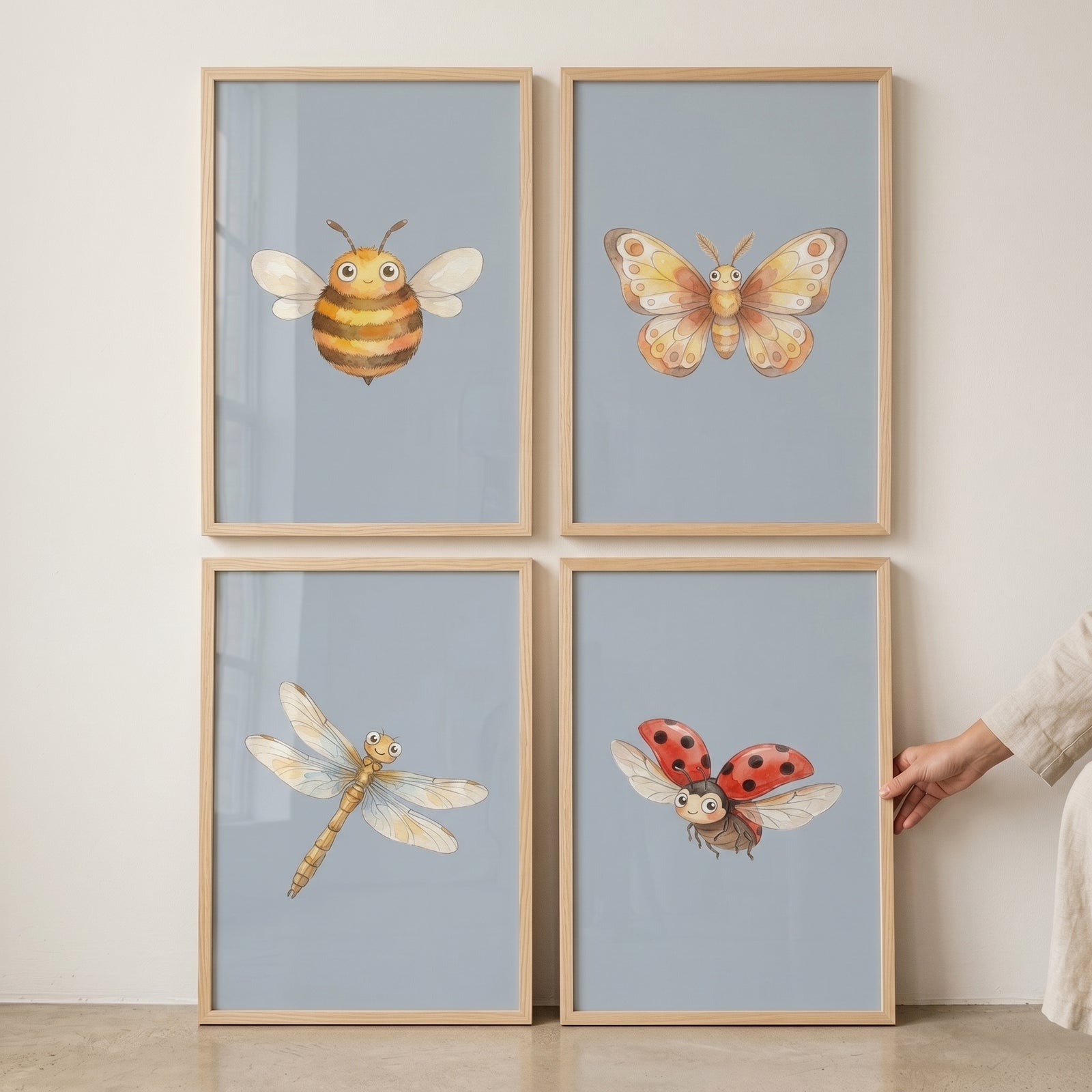 Smiling blue watercolor insect wall art set of 4 with a bee, butterfly, dragonfly, and ladybug in wood frames.