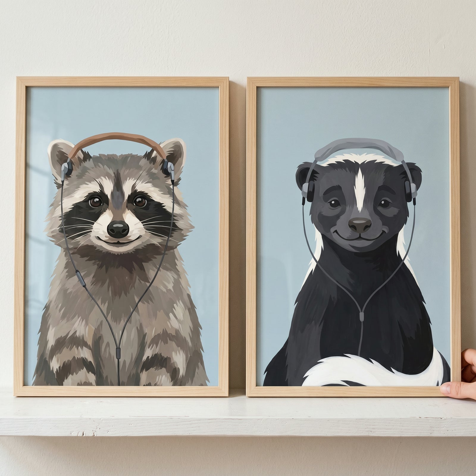 Smiling headphone woodland animal wall art set of 2 featuring a raccoon and a skunk in light wood frames.