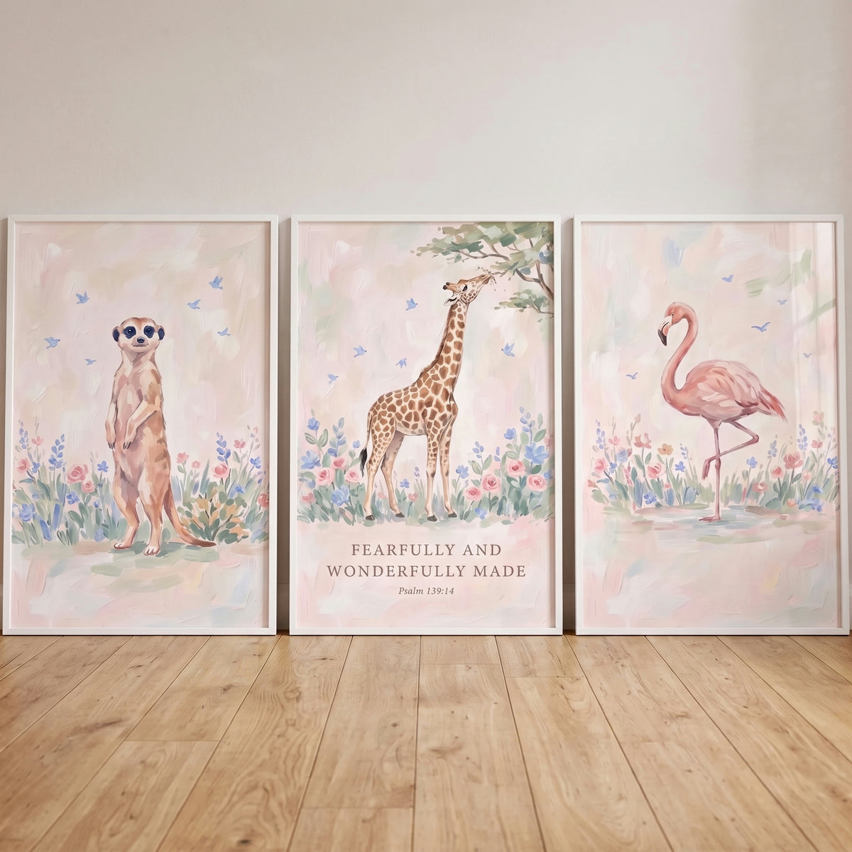 Soaring songbird african animals wall art set of 3 shows a meerkat, giraffe, and flamingo among flowers in pastel colors.