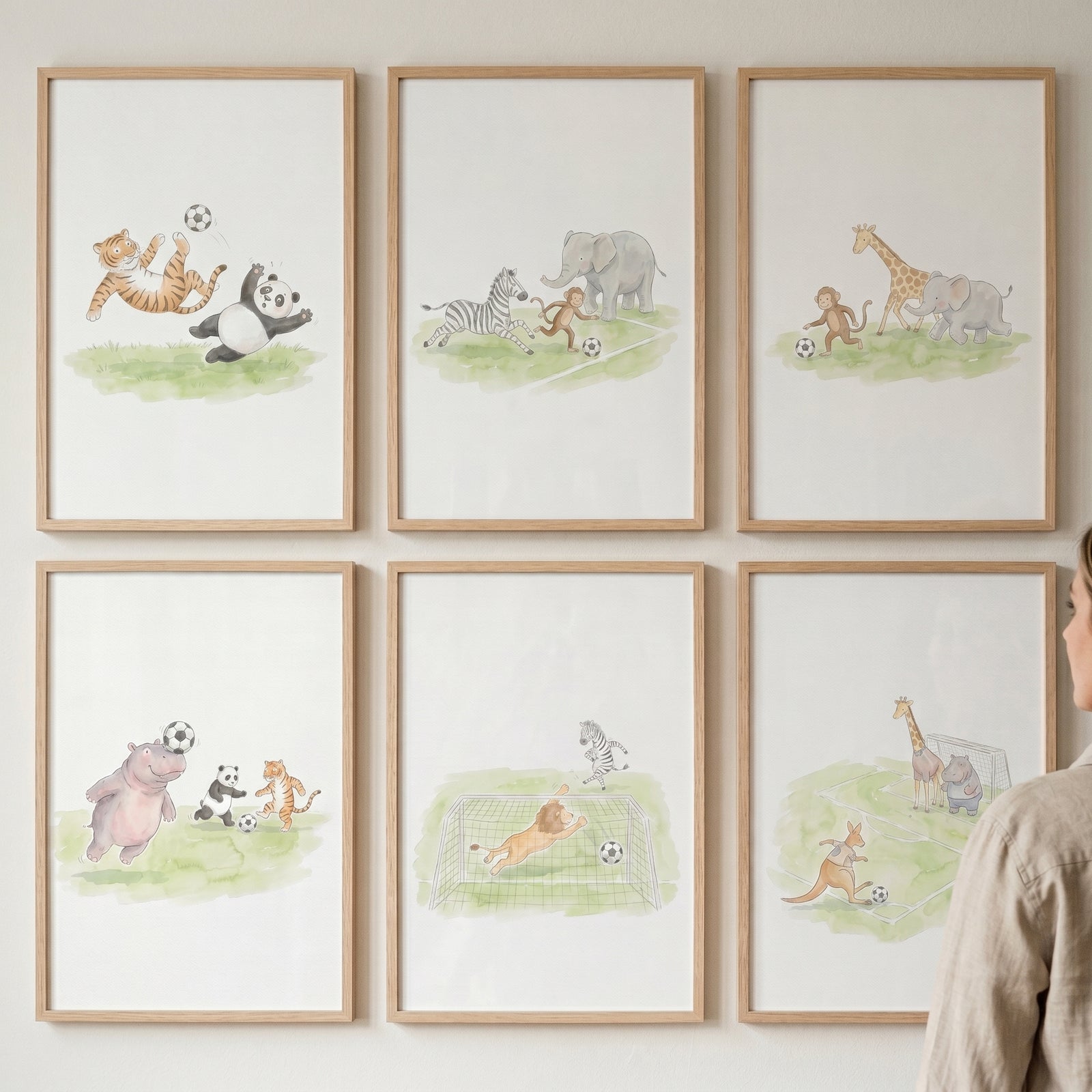 Soccer playing safari animals wall art set of 6 featuring lions, giraffes, and pandas in light wooden frames.