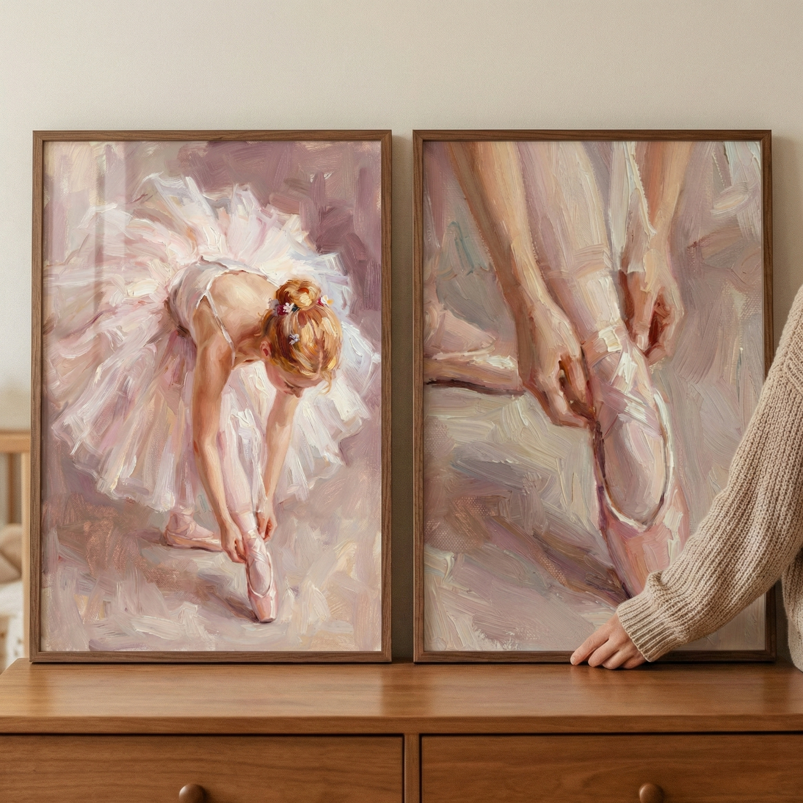 The artwork on the left depicts a dancer in a voluminous, pale pink tutu, leaning forward to adjust her pointe shoe. Her hair is gathered in a classic bun decorated with small pink blossoms. The piece on the right focuses on a close-up detail, showing a dancer’s hands carefully tying the long ribbons of a ballet slipper around their ankle. 
