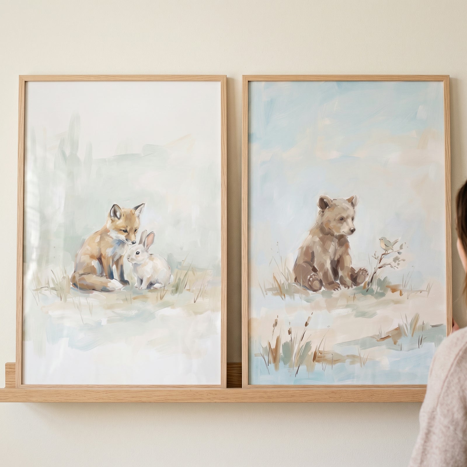 Soft blue baby animals wall art set of 2 shows a fox and rabbit next to a bear cub and bird in wooden frames.
