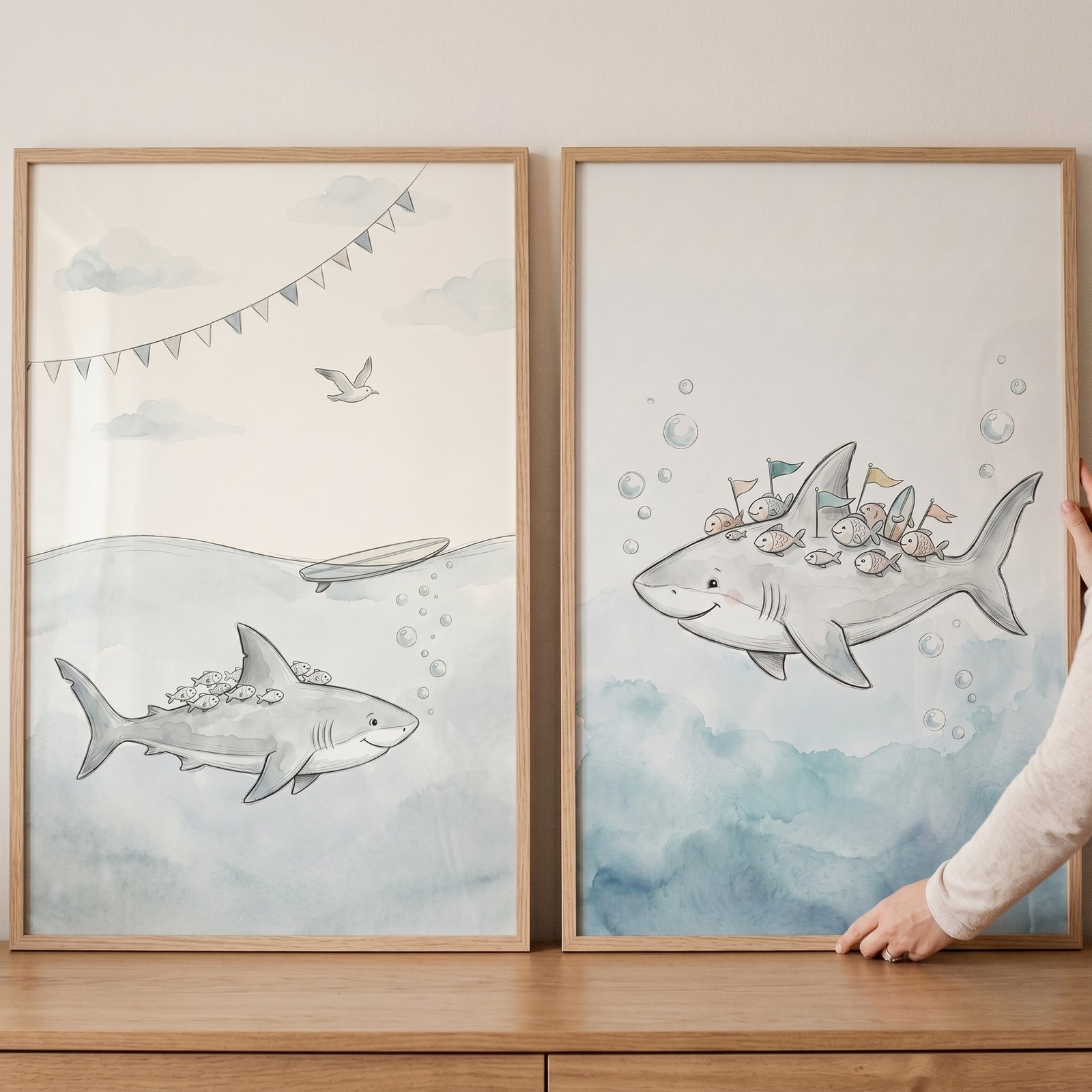 Soft blue smiling shark wall art set of 2 featuring watercolor illustrations of friendly sharks in light wood frames.