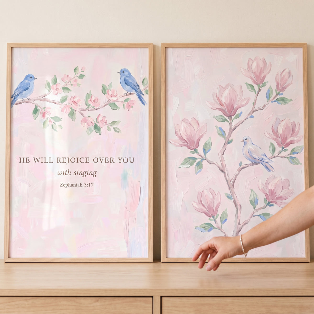 Soft blush botanical bird wall art set of 2 with blue birds, pink magnolia blossoms, and a Zephaniah 3:17 Bible verse.