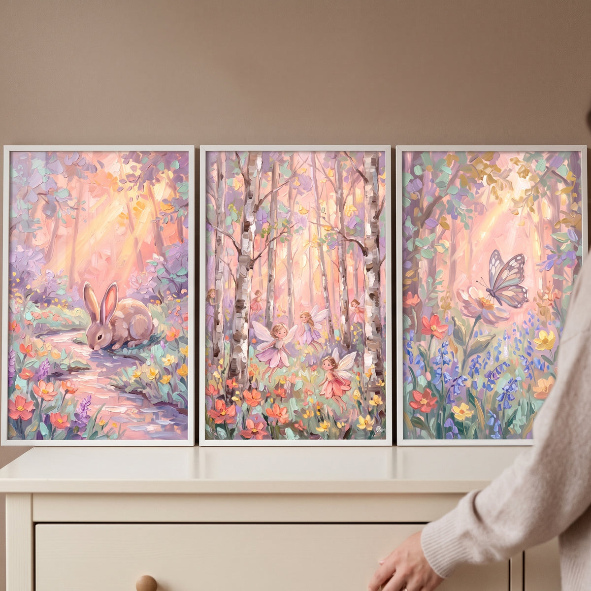 Soft blush enchanted forest wall art set of 3 with a rabbit, fairies, and a butterfly in pastel woodland scenes.