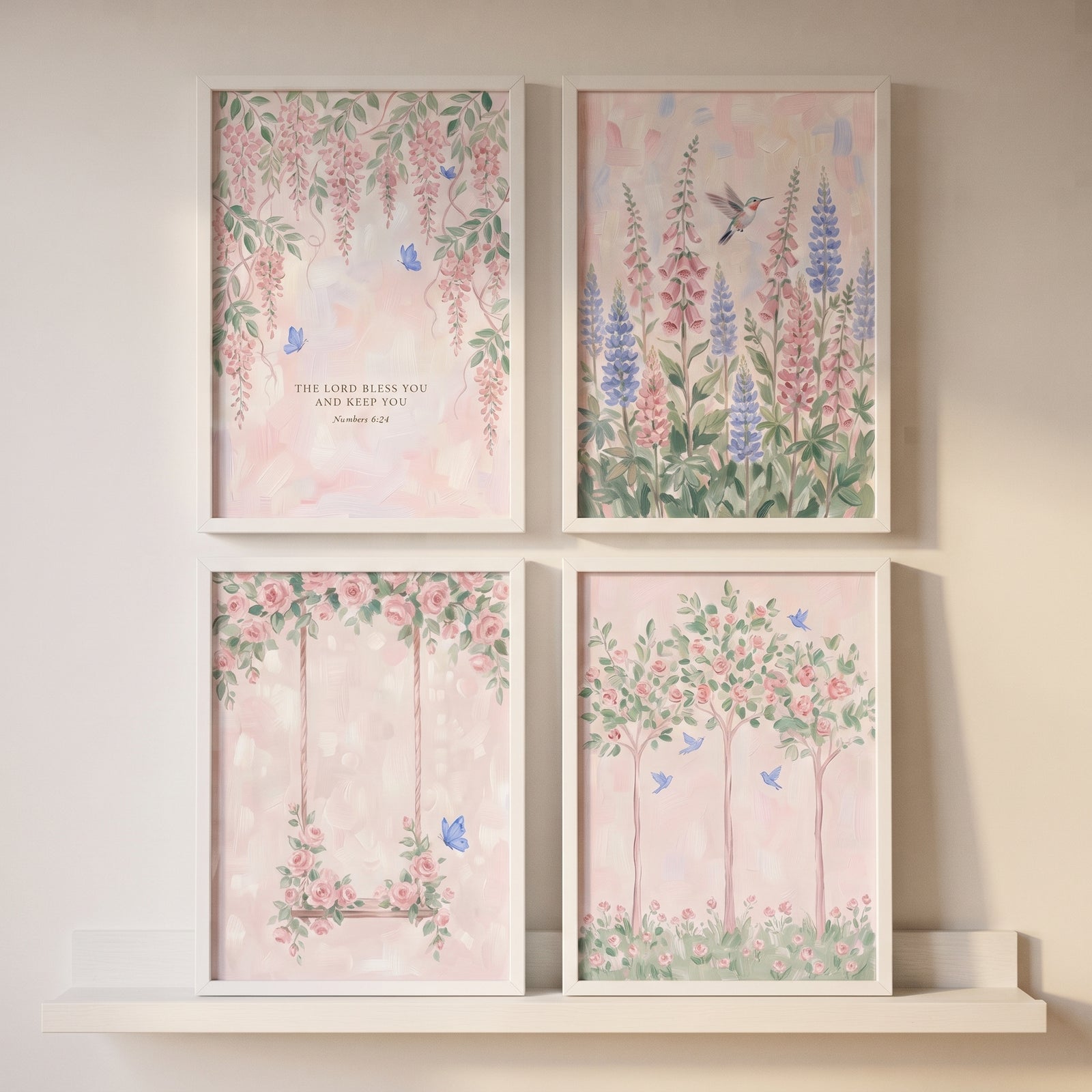 Soft blush pink garden wall art set of 4 with watercolor flowers, birds, and a swing in white frames on a shelf.