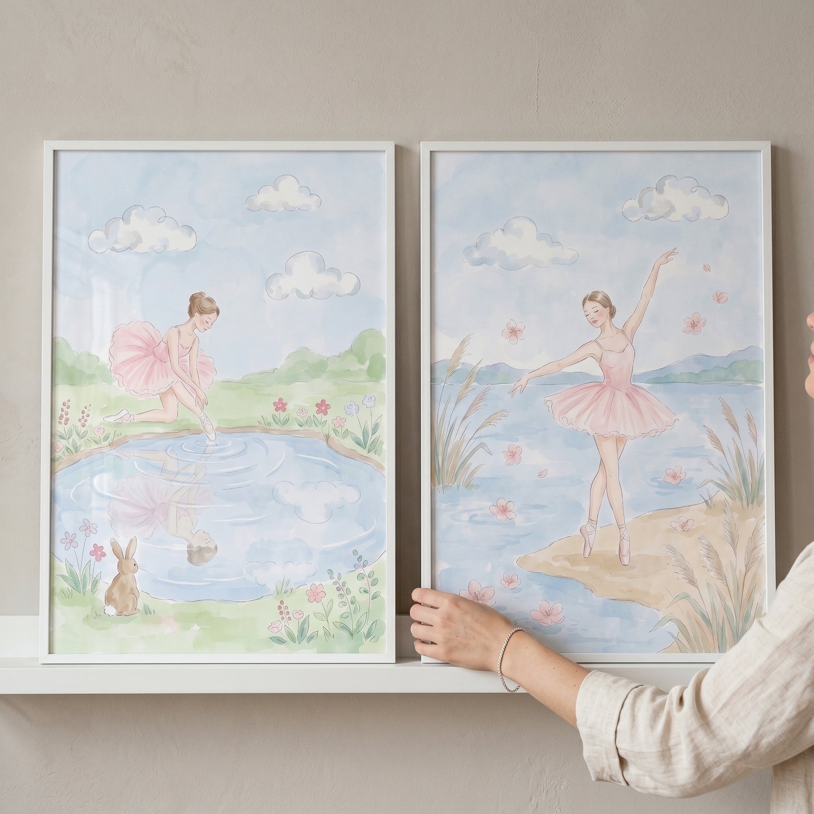 Ballerinas dancing by water with a bunny and flowers in this soft blush pink wall art set of 2.