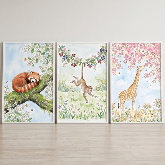 Soft botanical animal wall art set of 3 featuring a watercolor red panda, monkey, and giraffe in floral nature scenes.