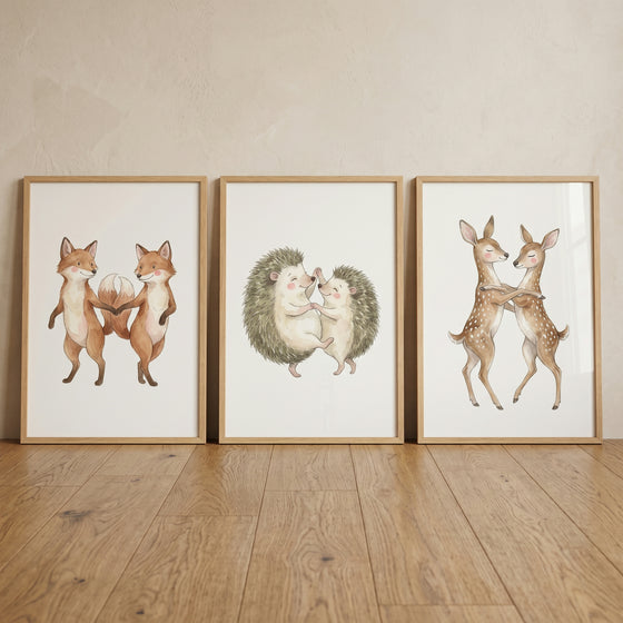 Framed soft dancing woodland animal wall art set of 3 shows foxes, hedgehogs, and deer in pairs on a wood floor.