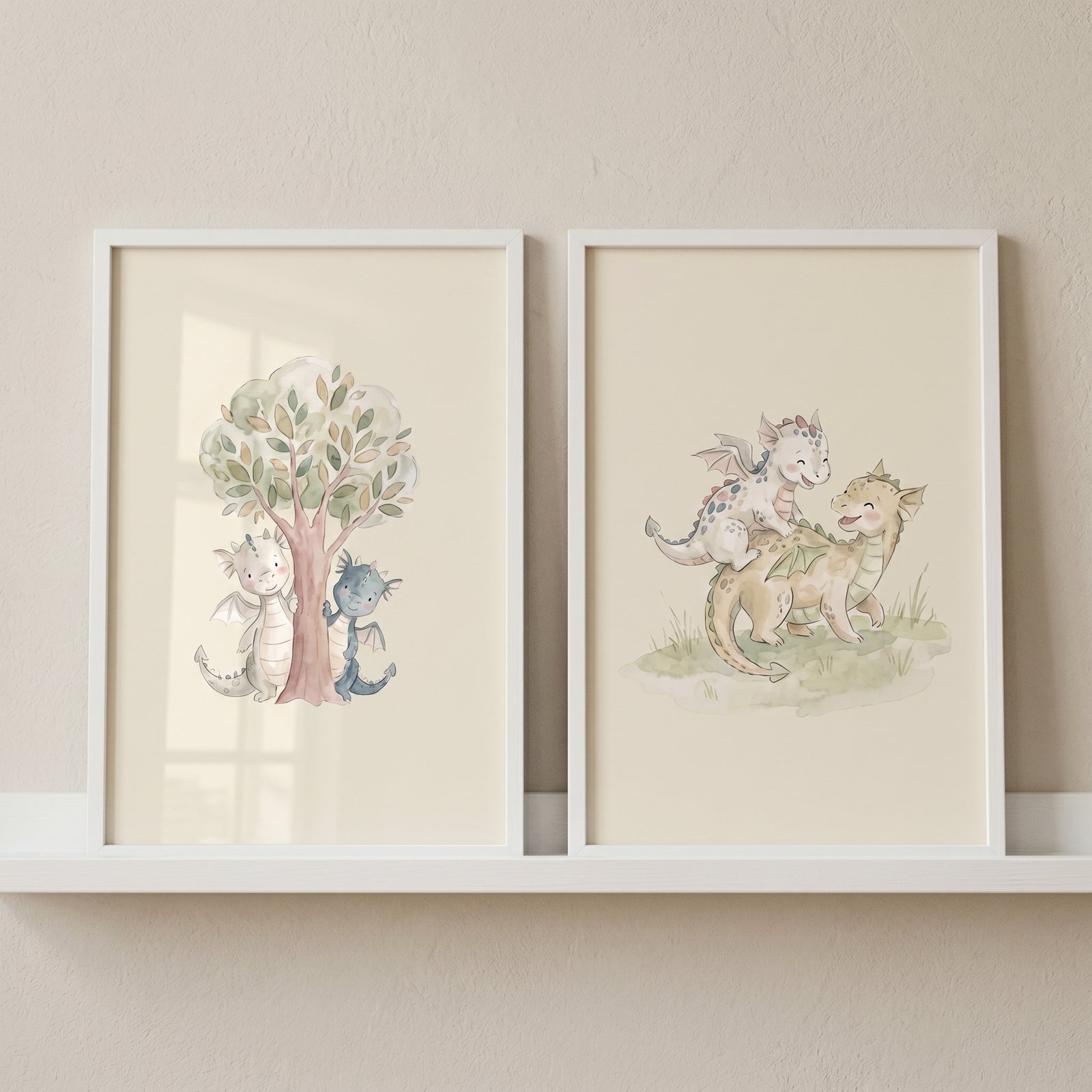 Watercolor soft fairytale baby dragons wall art set of 2 with cute dragons peeking near a tree and playing on grass.