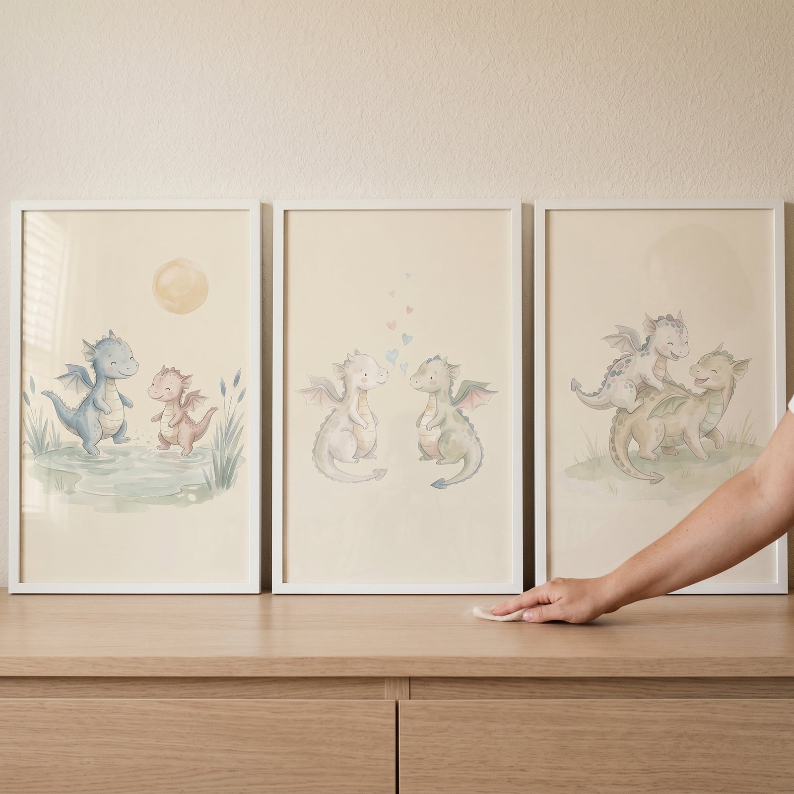 Watercolor illustrations of cute creatures in a soft green baby dragons wall art set of 3 on a neutral background.