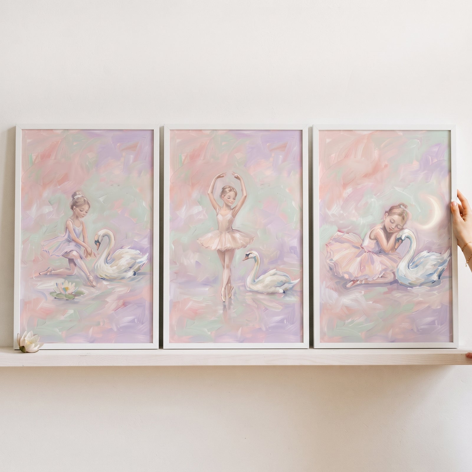 Soft lavender swan ballet wall art set of 3 featuring young dancers and swans in white frames on a shelf.