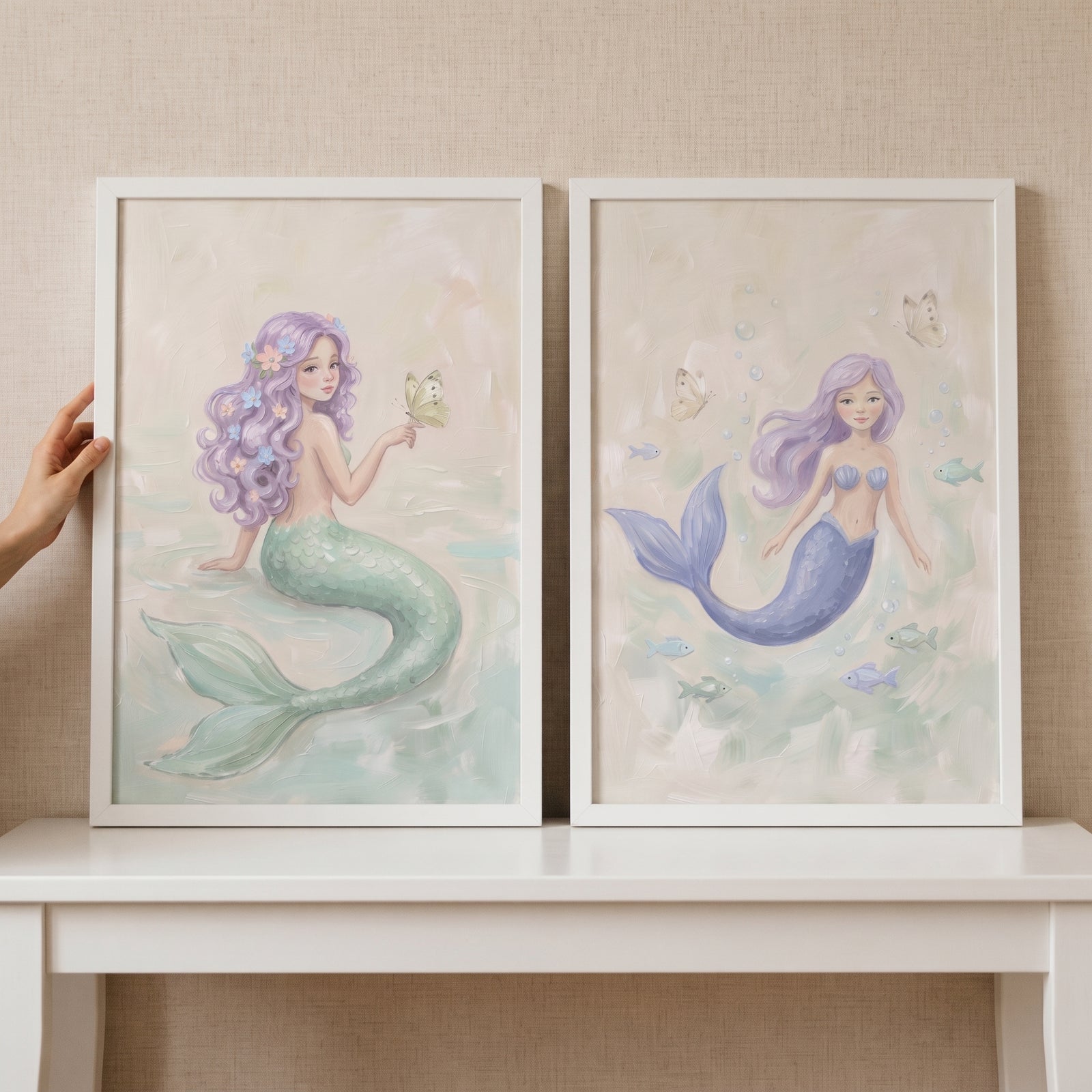 Soft lilac hair mermaid wall art set of 2 in white frames featuring pastel mermaids with green and blue tails.