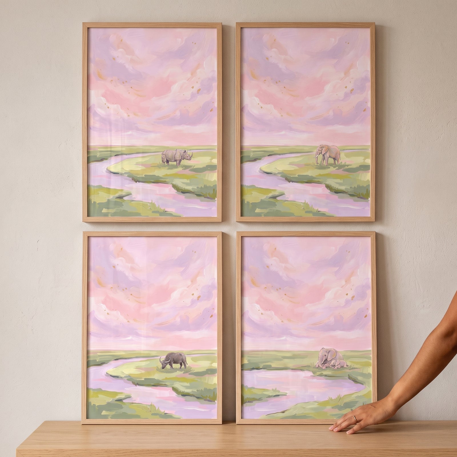 Soft lilac safari animals wall art set of 4 features elephants, a rhino, and a buffalo in a pastel river landscape.