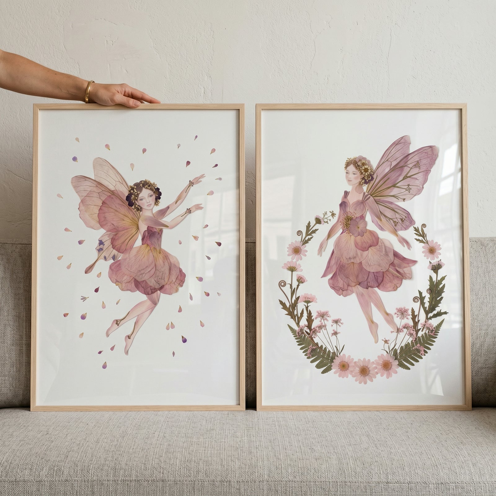 Soft mauve botanical fairy wall art set of 2 framed prints featuring delicate winged figures and floral details.