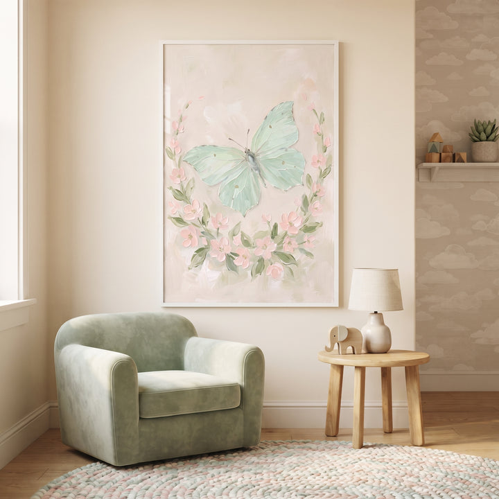 Soft mint green butterfly wall art hangs above a plush chair and wooden side table with a lamp in a neutral nursery.