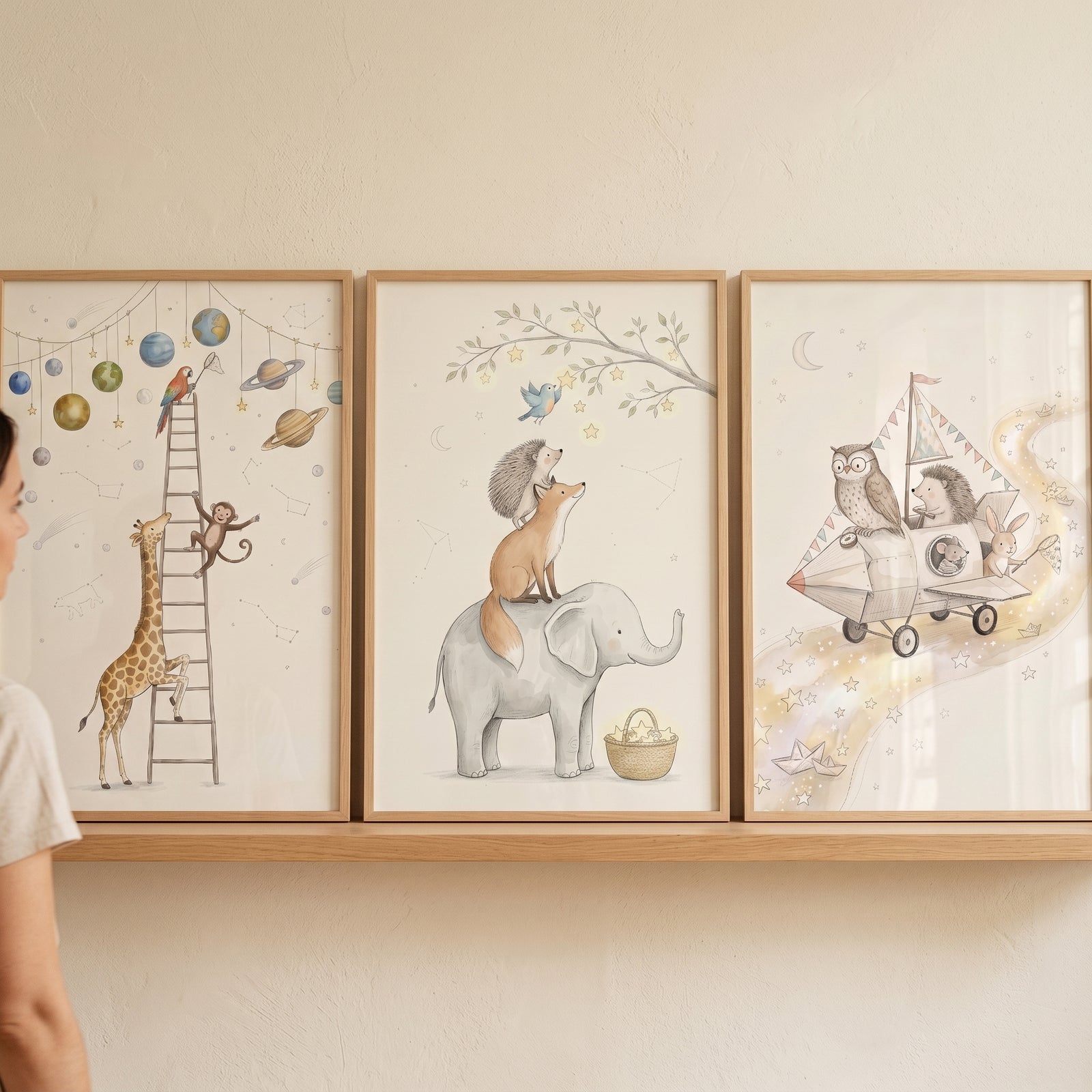 Soft neutral celestial animals wall art set of 3 featuring whimsical animals and planets in light wood frames.