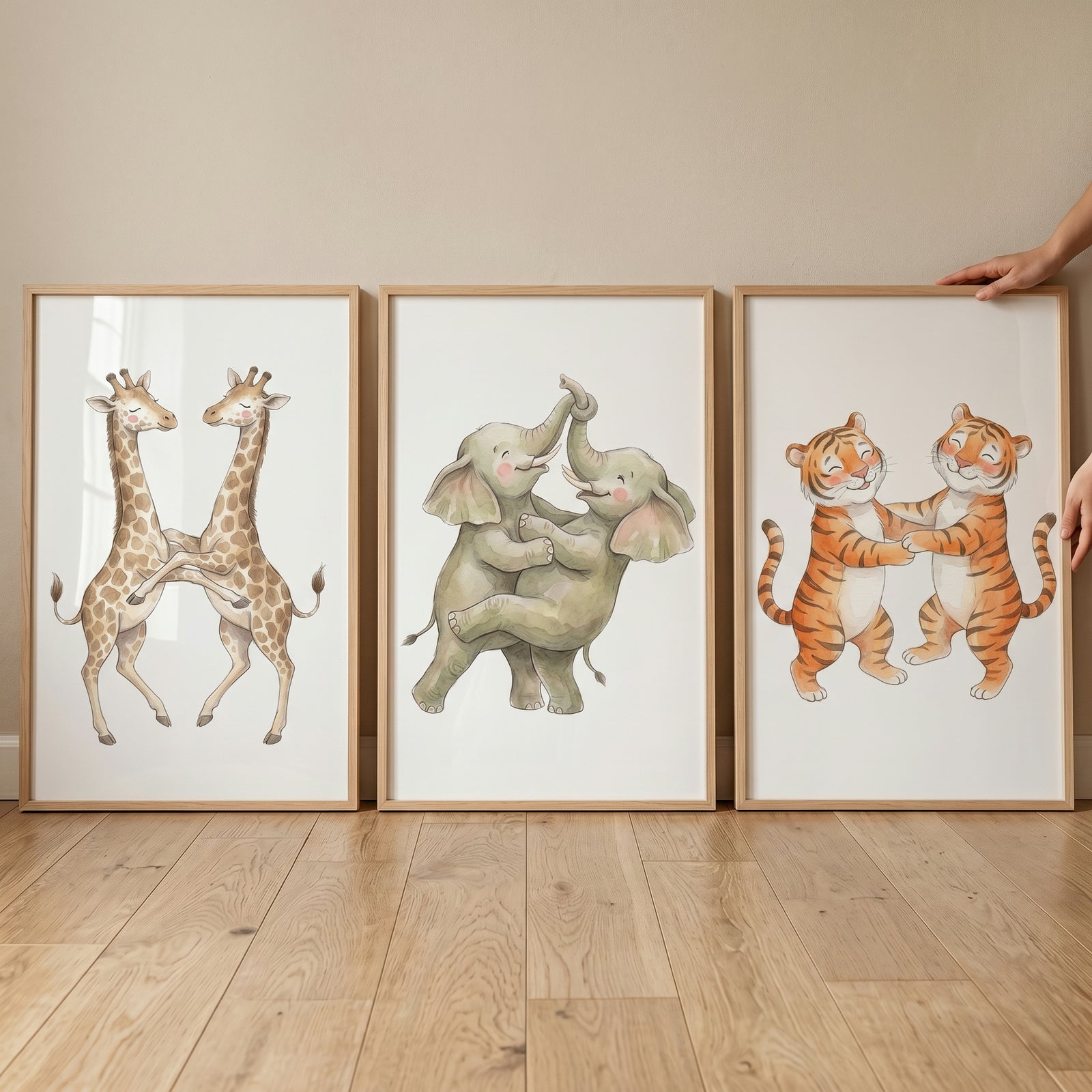 Soft neutral hugging animal wall art set of 3 featuring watercolor illustrations of giraffes, elephants, and tigers.