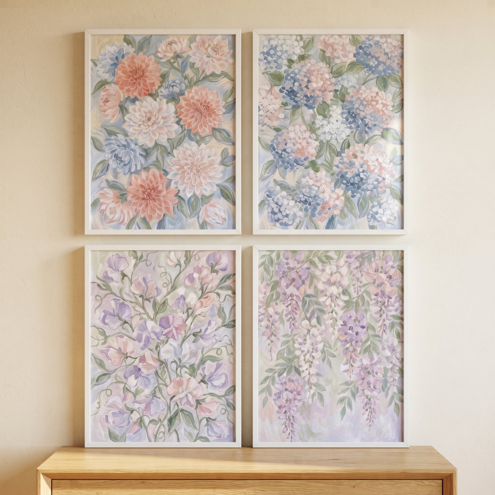 Soft palette impressionist floral wall art set of 4 featuring pastel blooms in white frames above a wooden surface.