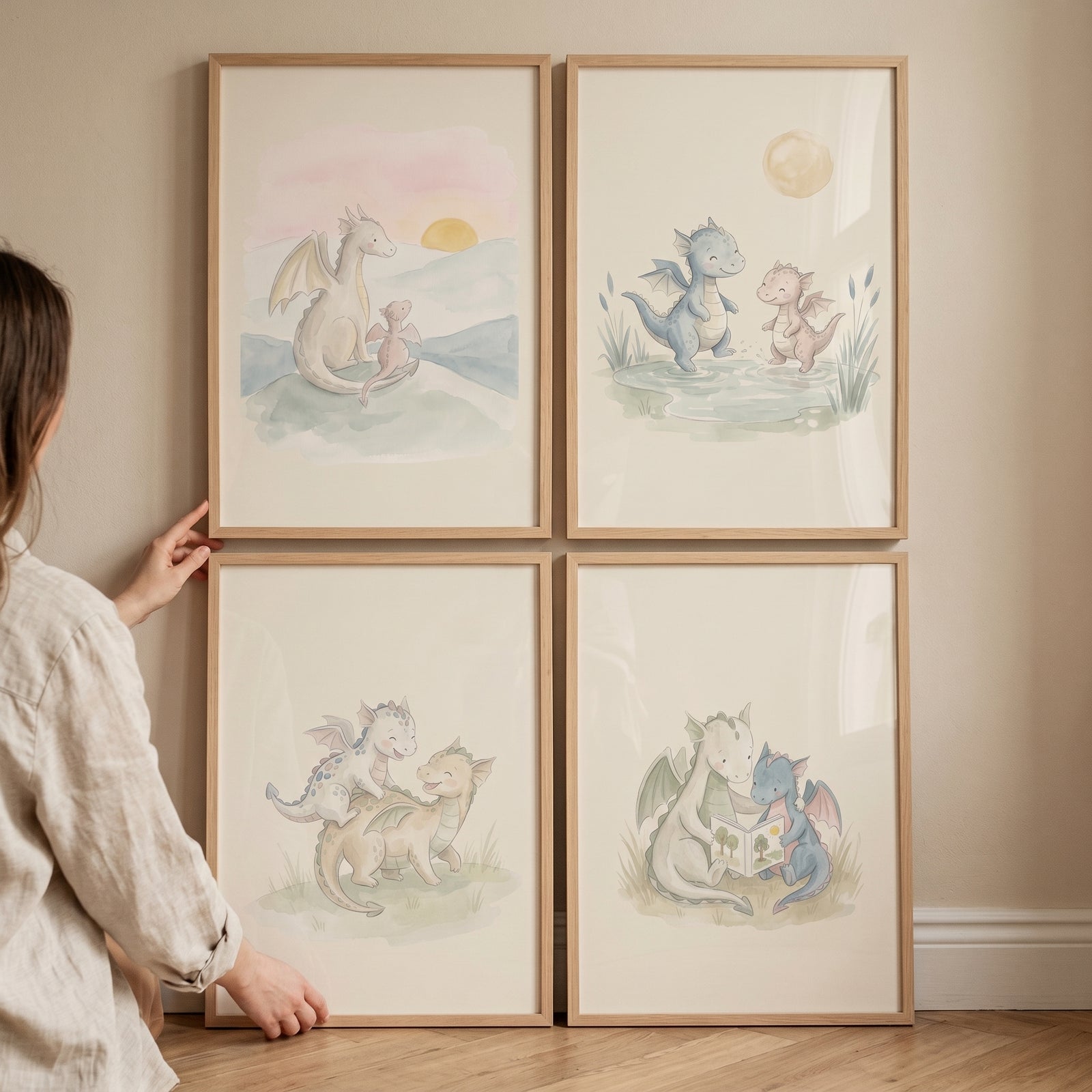 Soft pastel baby dragon wall art set of 4 in light wood frames held against a neutral wall.