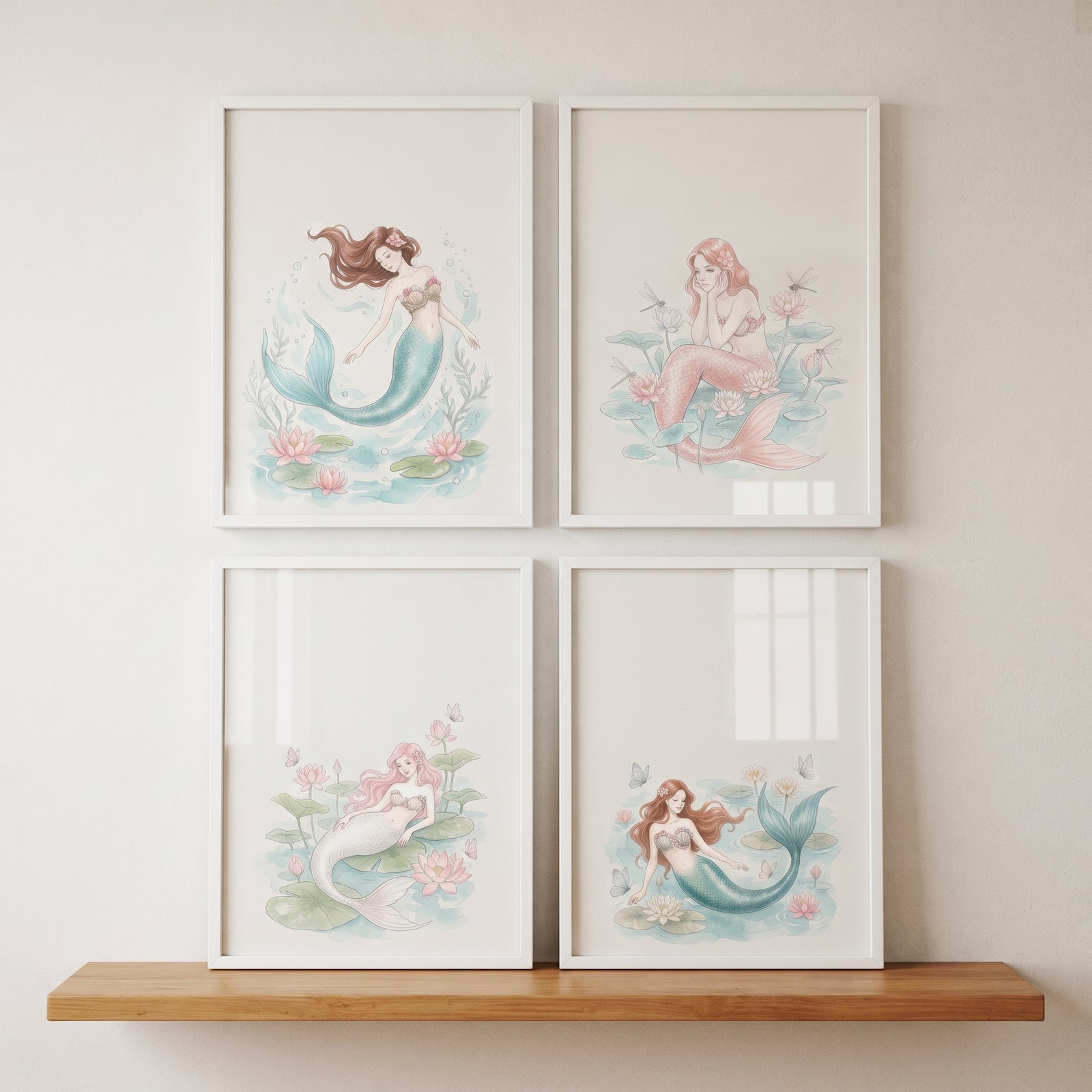 Soft pastel floral mermaid wall art set of 4 in white frames hanging on a wall above a wooden shelf.