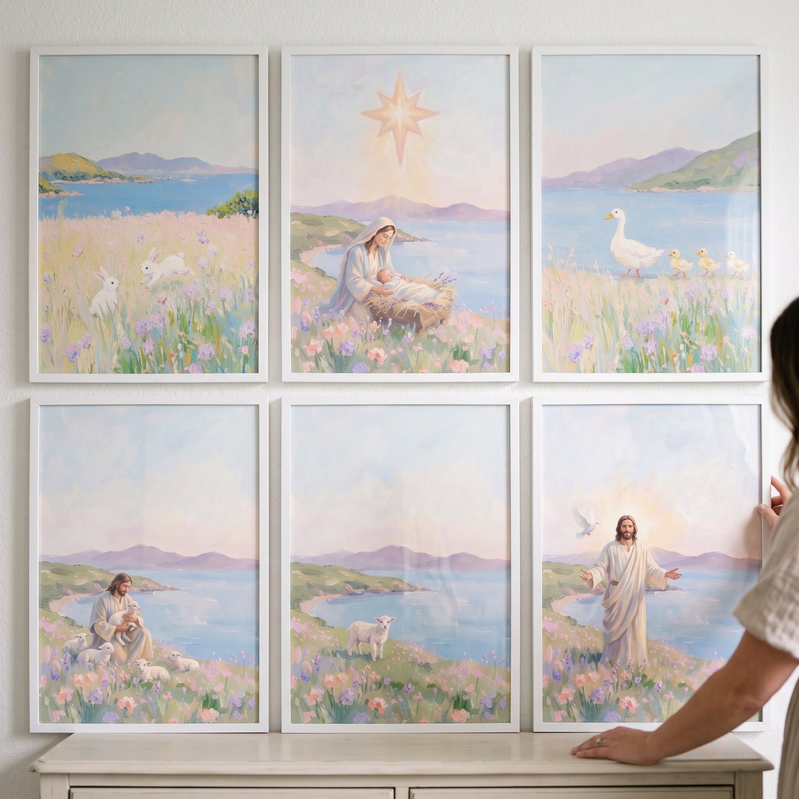 Soft pastel landscape coastal wall art set of 6 featuring Jesus, Mary, and nature scenes in white frames on a wall.