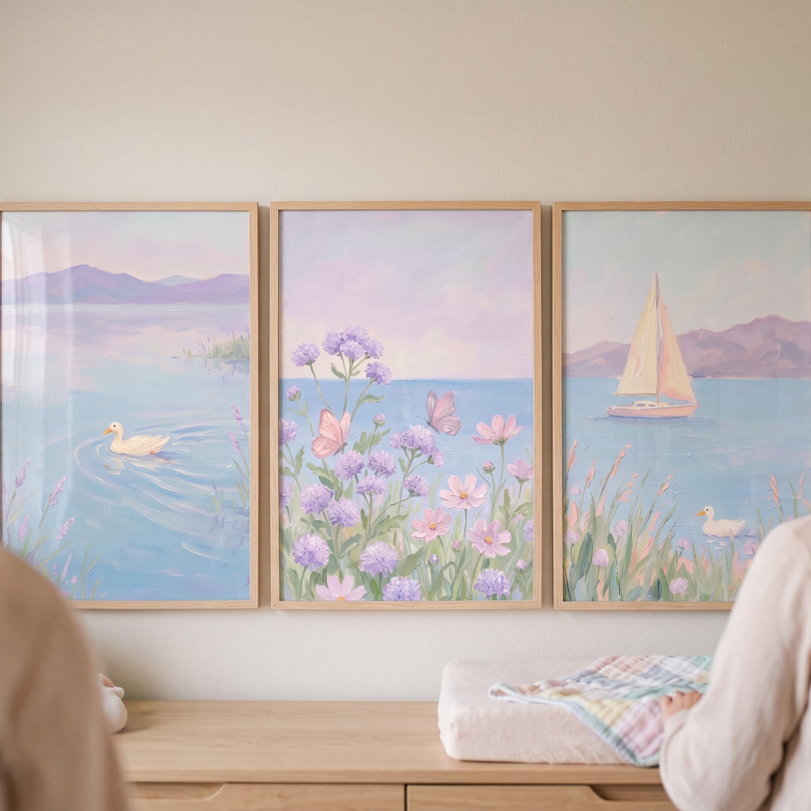 Soft pastel lavender landscape wall art set of 3 with ducks on a lake, butterflies in flowers, and a sailboat at sea.