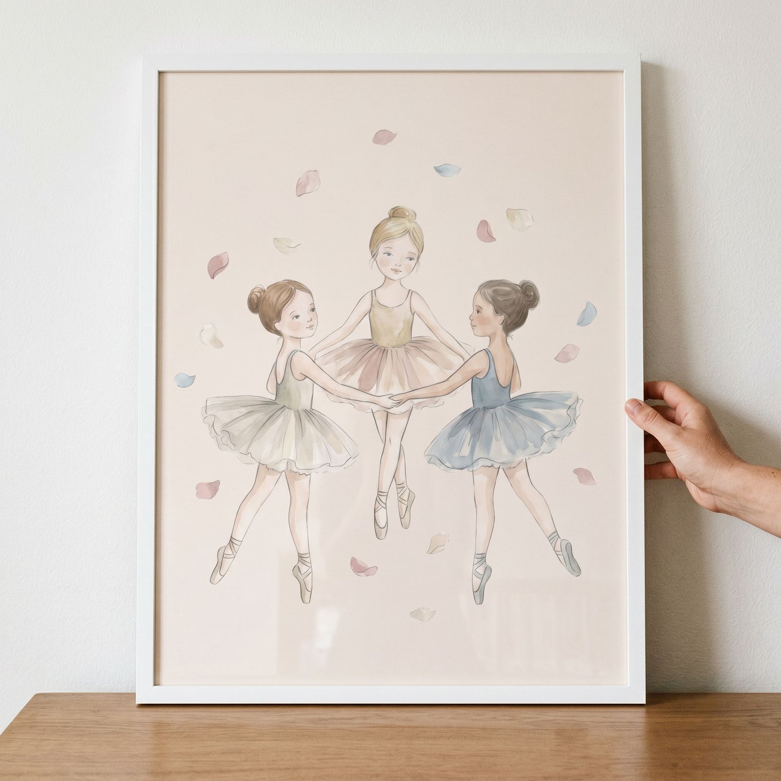 Three young girls in tutus dance in a circle surrounded by petals in this soft pastel petal ballerina wall art.