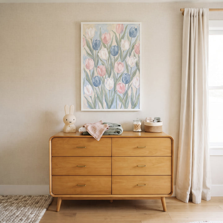 Soft pastel pink tulip floral wall art above a wooden dresser with a rabbit-shaped lamp and cream curtains.