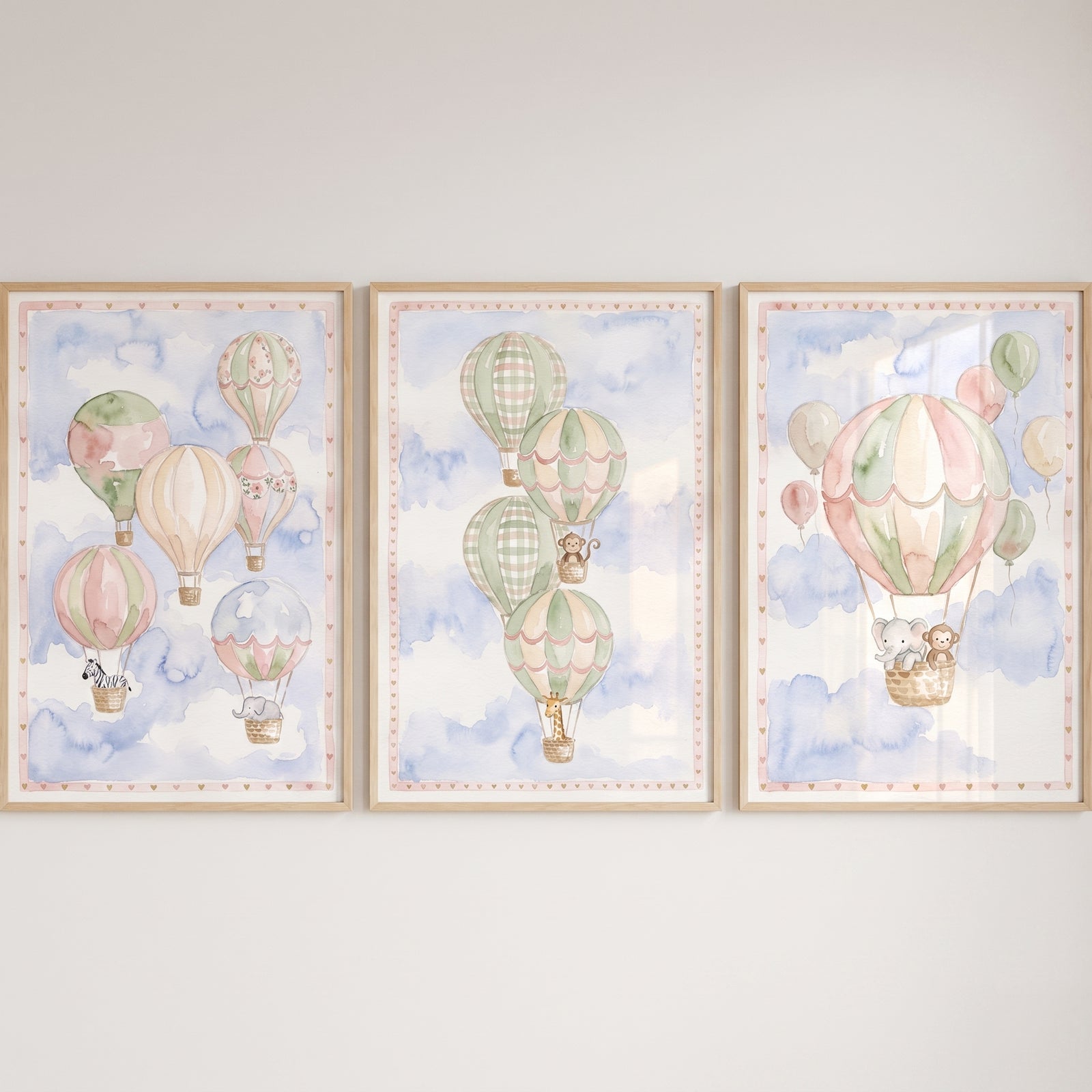 Soft pastel safari animal wall art set of 3 featuring hot air balloons with a zebra, elephant, giraffe, and monkey.