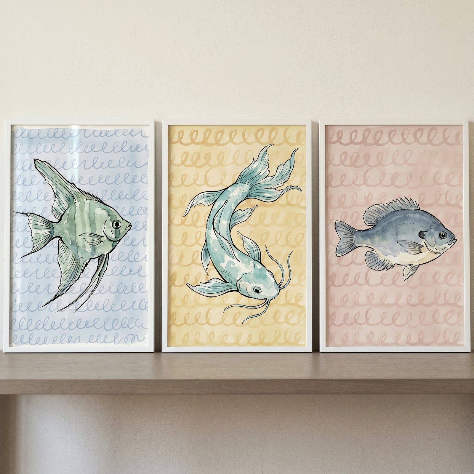 Soft pastel watercolor fish wall art set of 3 in frames on a shelf, with blue, yellow, and pink patterned backgrounds.
