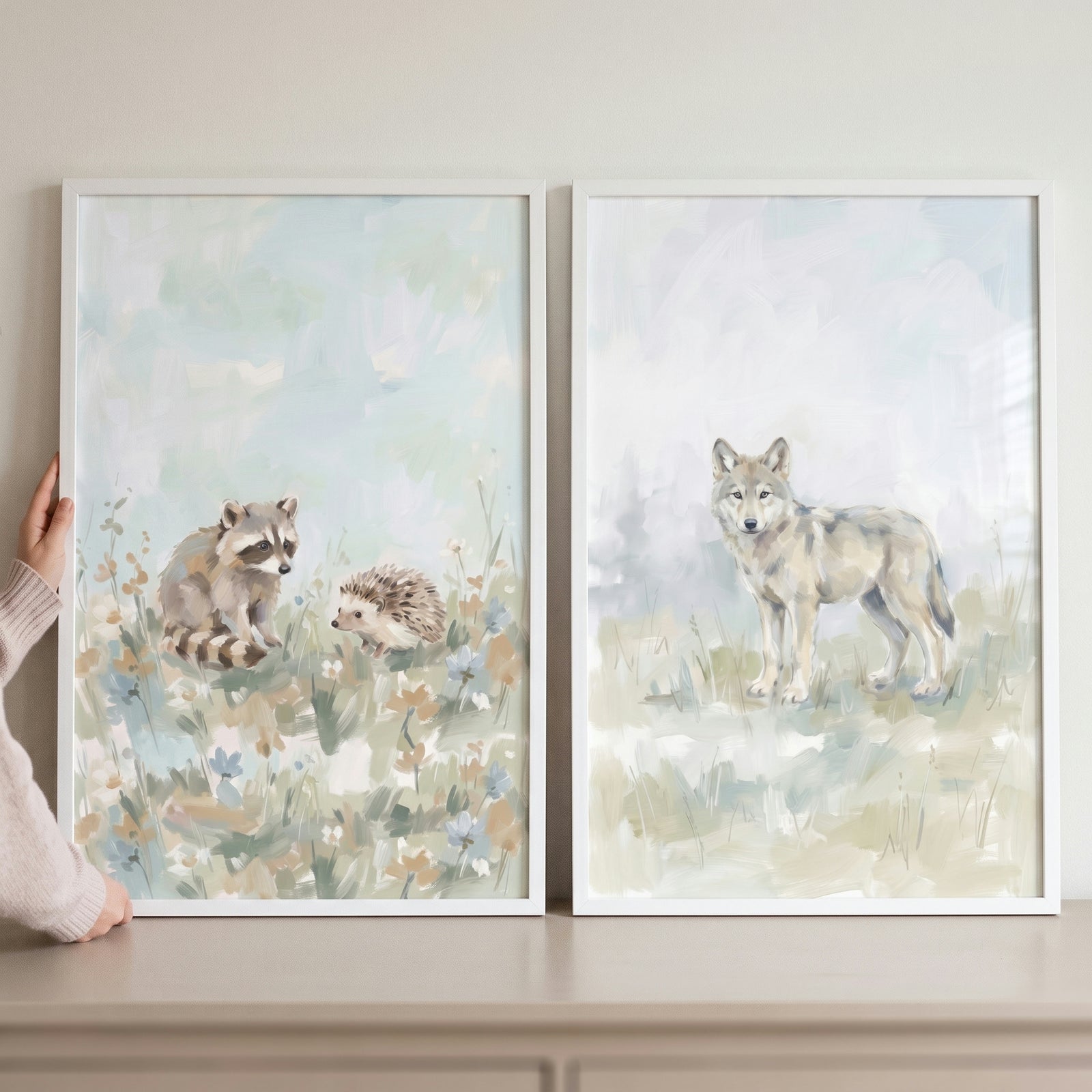 Framed soft pastel woodland animals wall art set of 2 featuring a raccoon, hedgehog, and wolf in a muted field.