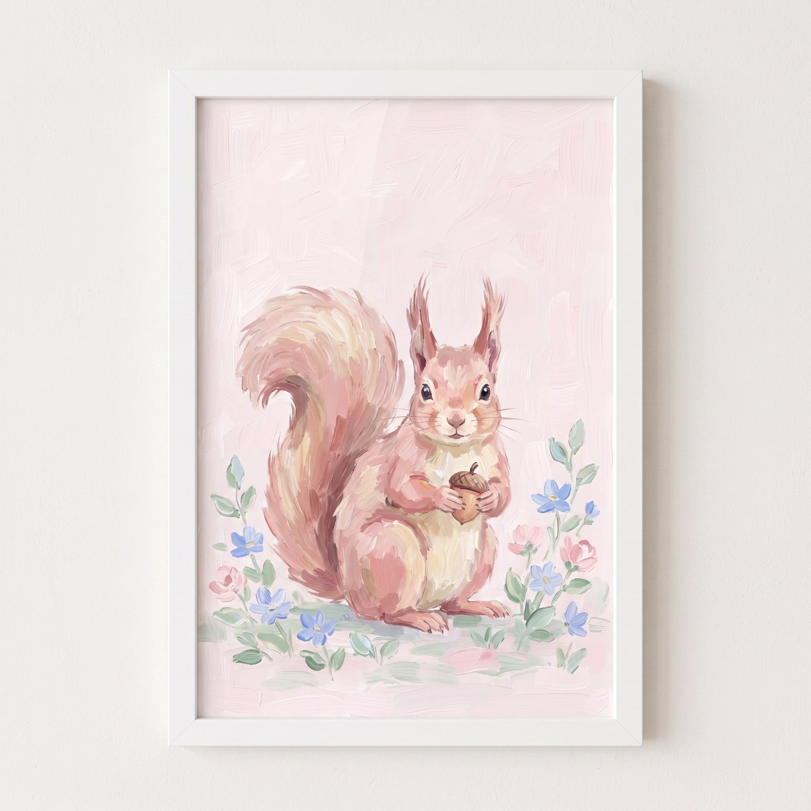 Soft pink acorn squirrel wall art shows a cute squirrel holding an acorn among flowers in a white frame.