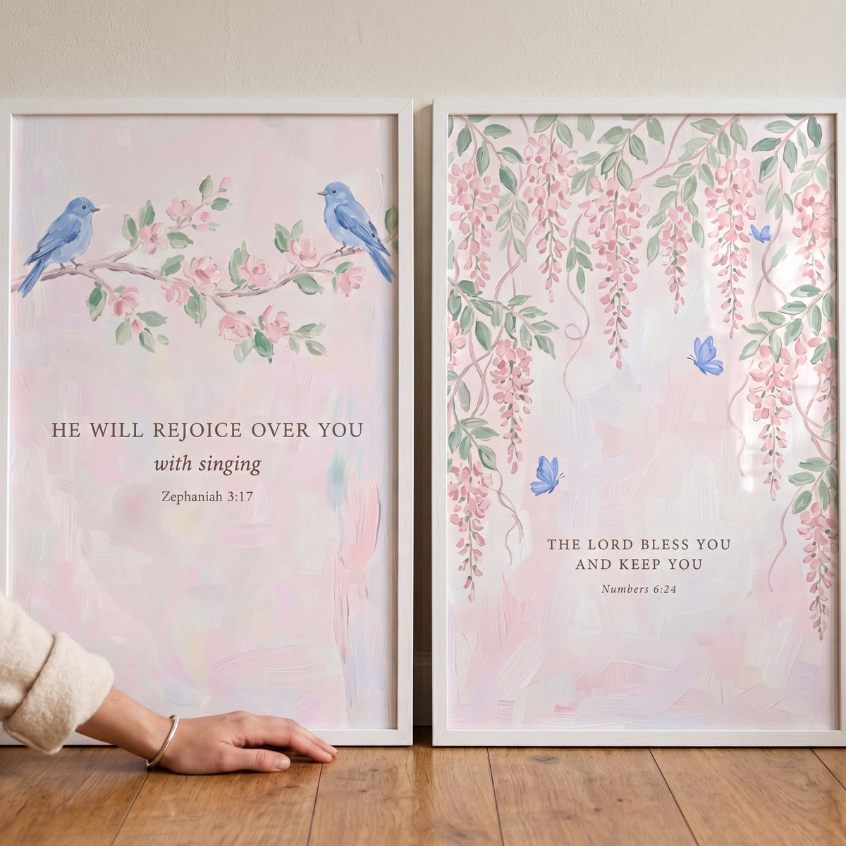 Soft pink botanical scripture artwork set of 2 featuring blue birds, pink flowers, and Bible verses in white frames.