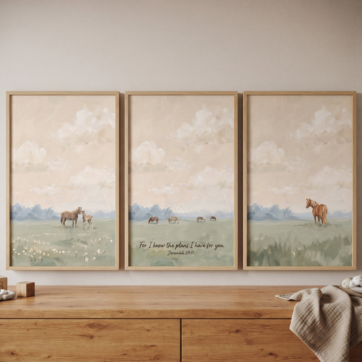 Soft sage landscape horse wall art set of 3 depicts horses in a field with a scripture verse above a wooden dresser.
