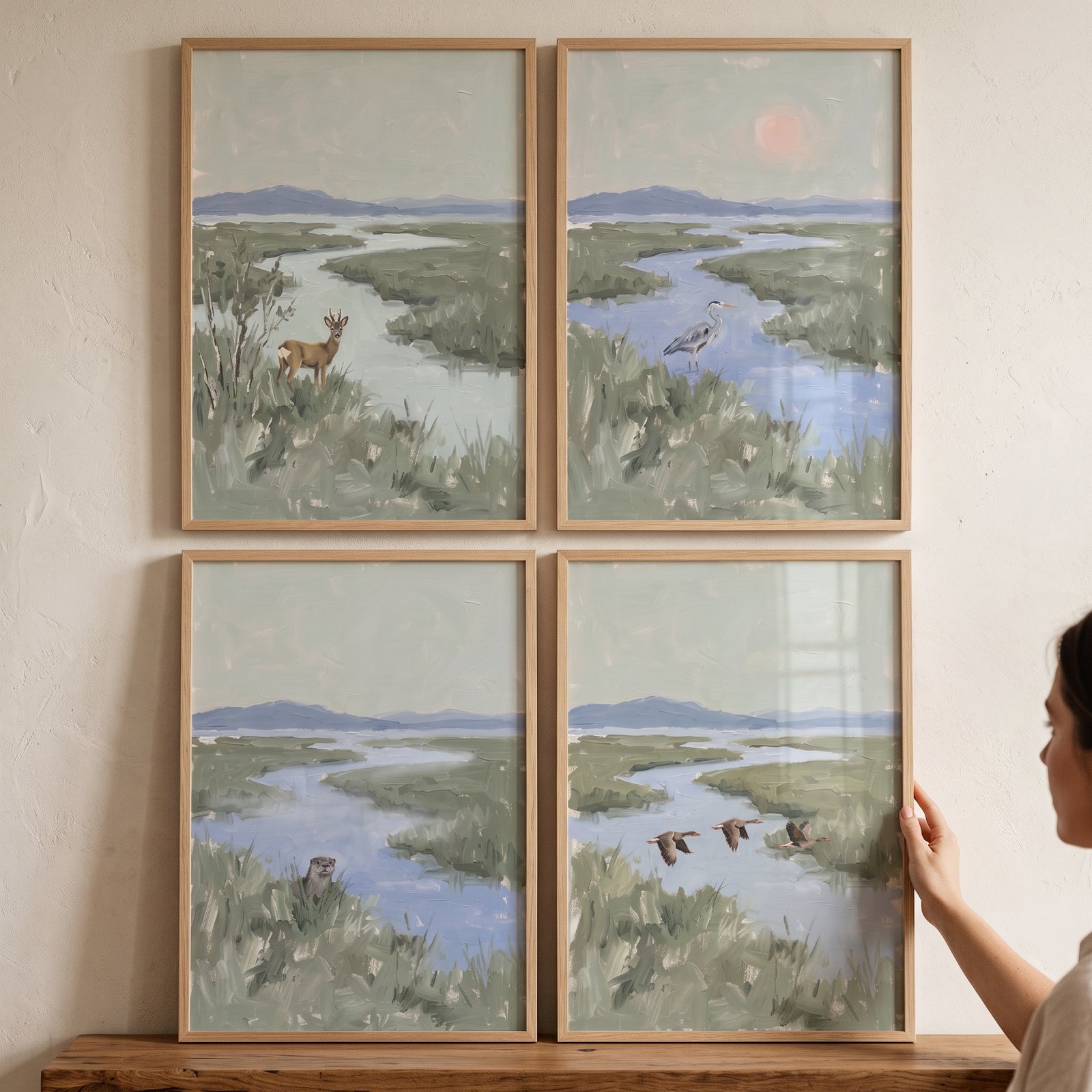 Soft sage wetland animals wall art set of 4 depicts a deer, heron, otter, and birds in peaceful river landscapes.