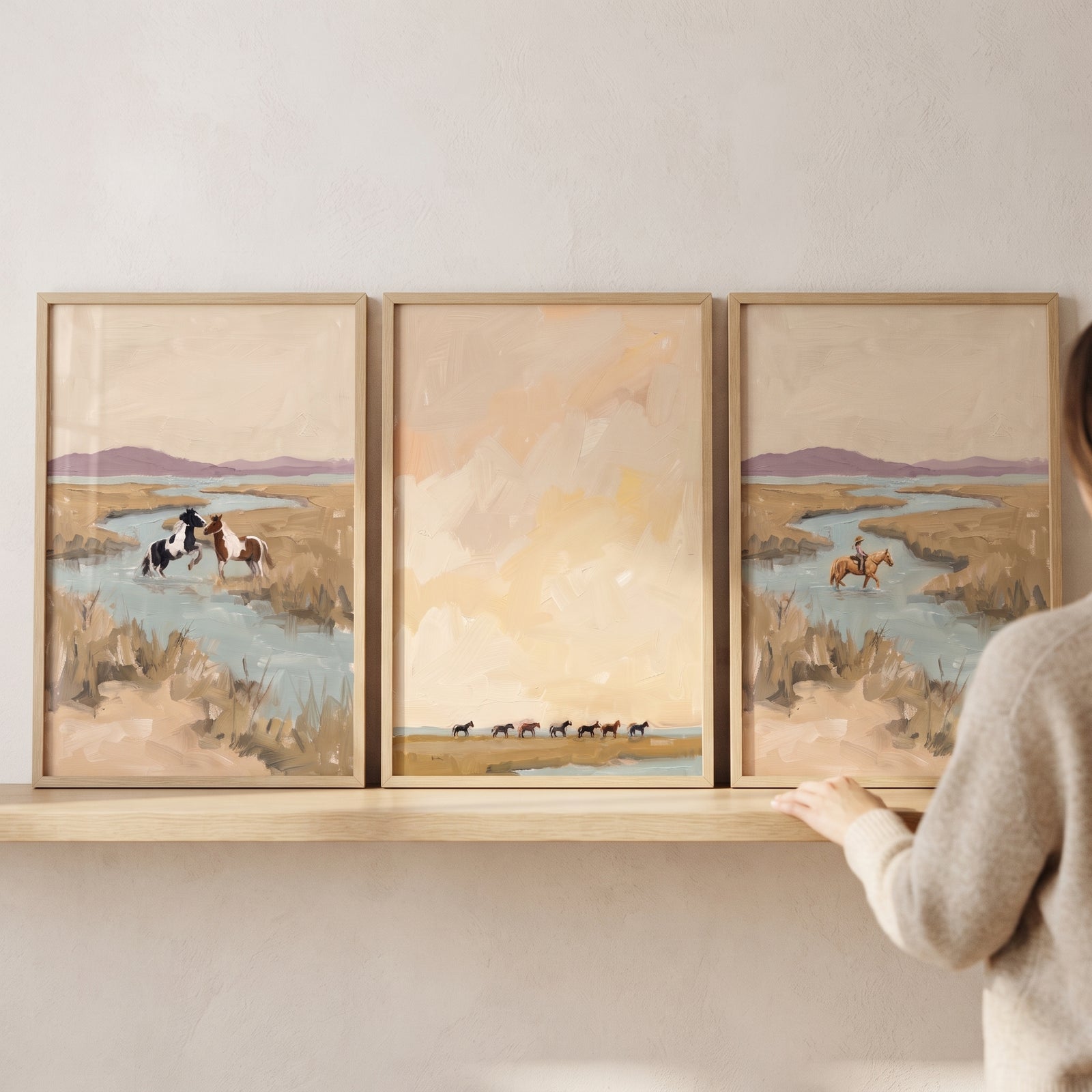 Soft sage wetland horses wall art set of 3 featuring horses and a rider by a winding river in a muted landscape.