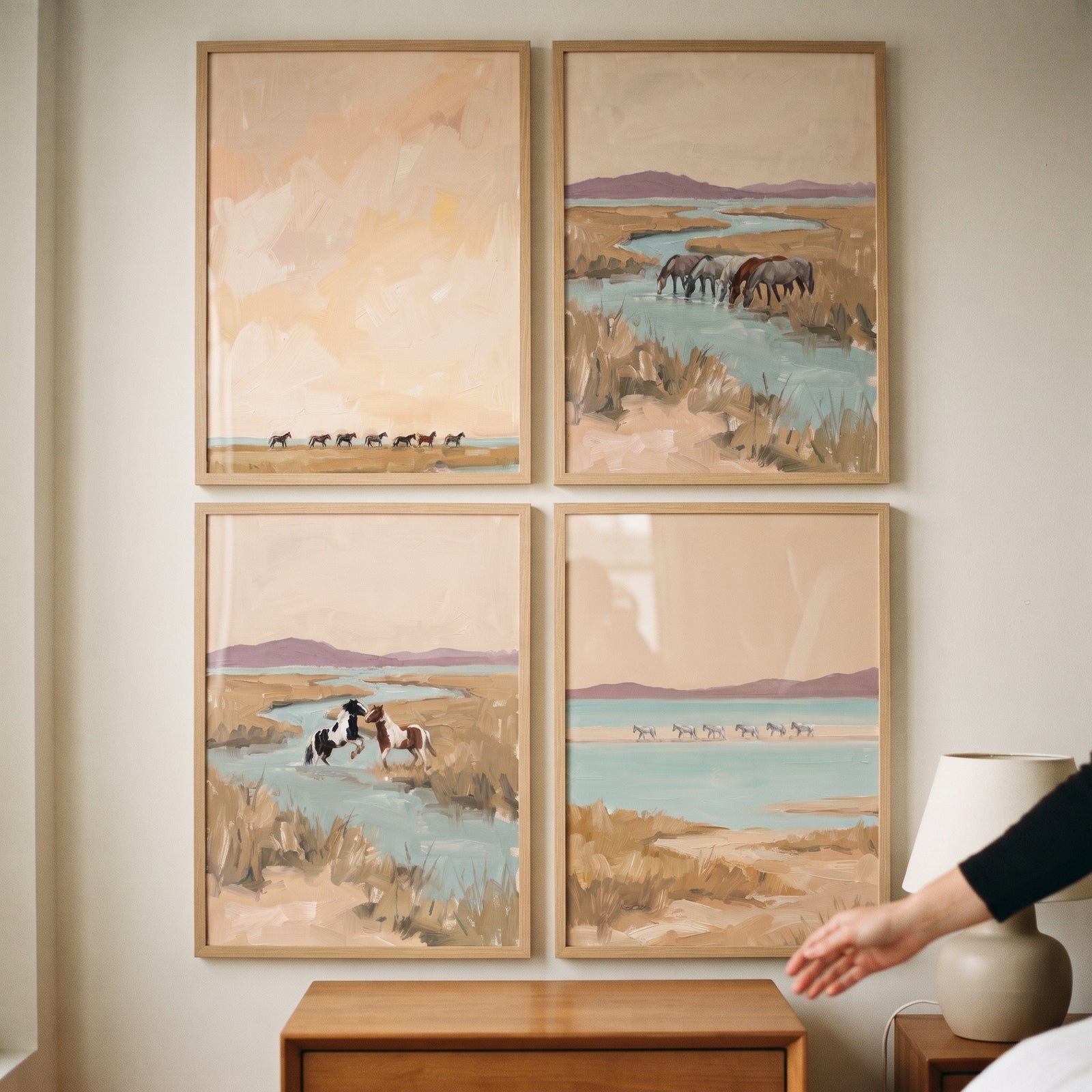 Soft sand marshland horses wall art set of 4 features horses near water in muted tones of beige, blue, and lavender.