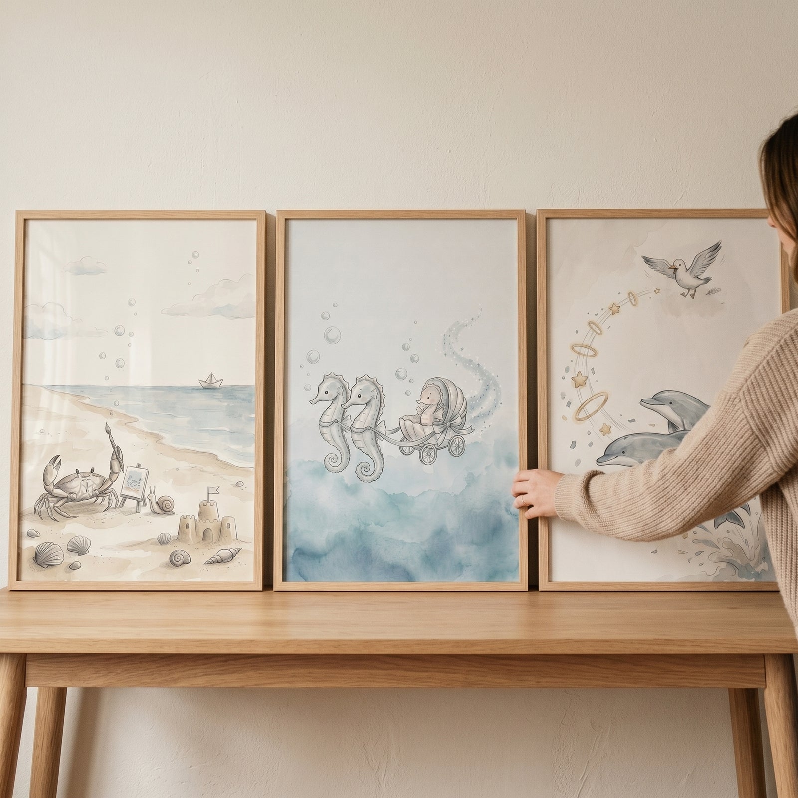 Soft sandy sea animal wall art set of 3 featuring a beach crab, a seahorse carriage, and leaping dolphins in wood frames.