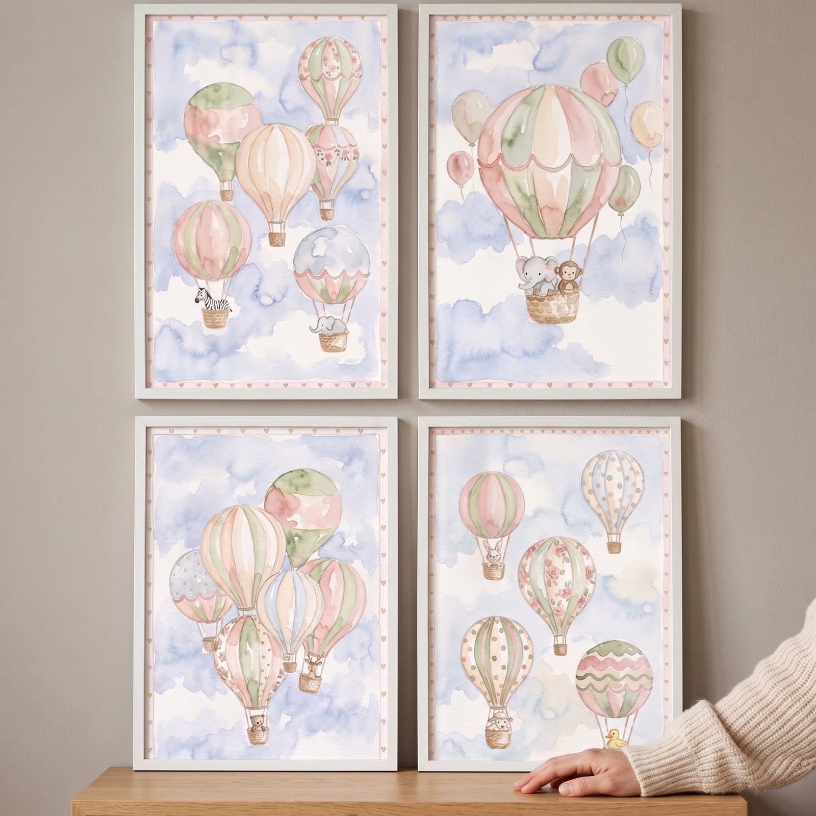 Soft sky animal balloon wall art set of 4 with cute animals in pastel hot air balloons on a cloudy blue background.