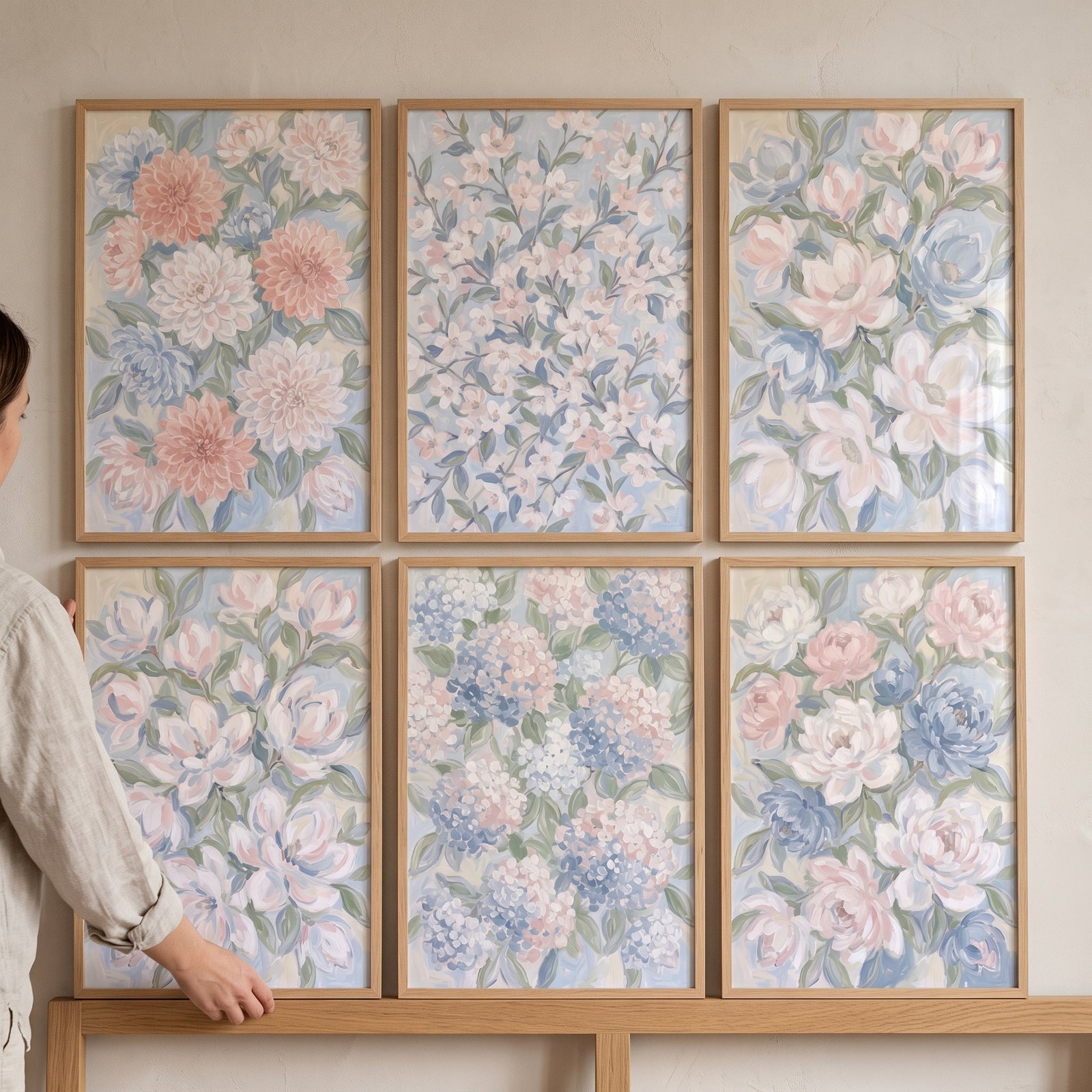 Soft spring garden floral wall art set of 6 featuring pastel flower prints in light wood frames on a plain wall.
