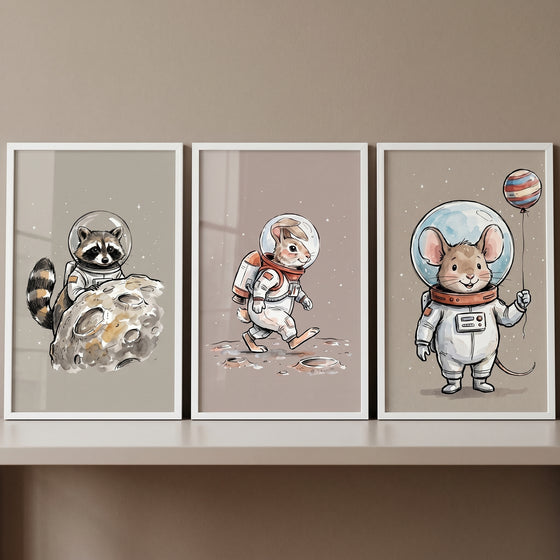 Soft watercolor astronaut animal wall art set of 3 with a raccoon, rabbit, and mouse in space suits.
