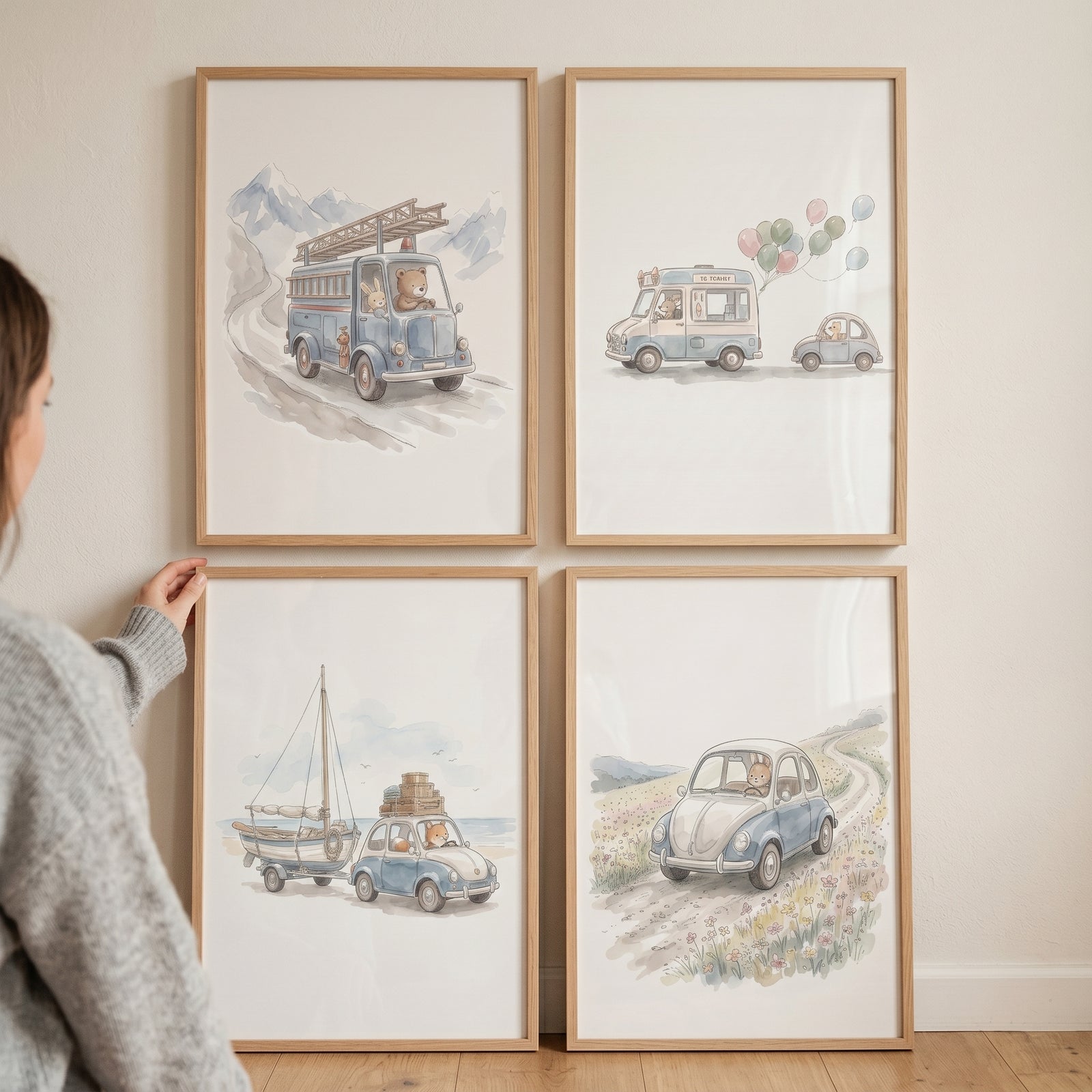 A woman's hand adjusts a soft watercolor driving animals wall art set of 4 featuring bears driving vintage vehicles.