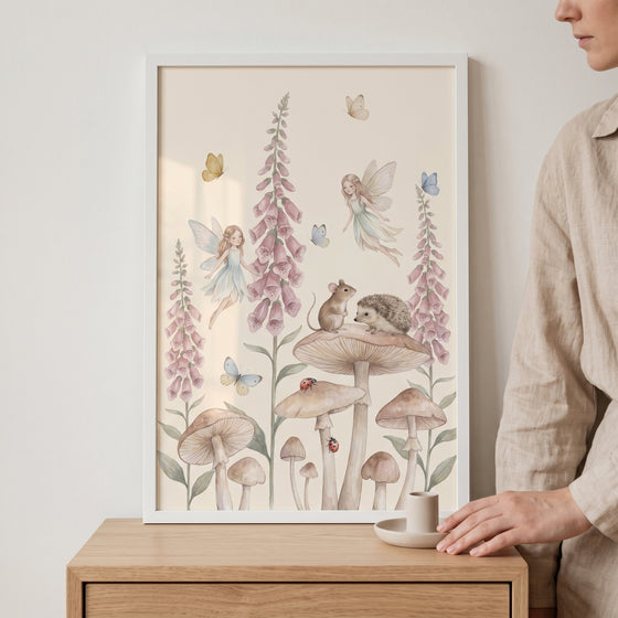 Framed soft watercolor garden fairies wall art with a mouse, hedgehog, and butterflies among mushrooms and pink flowers.