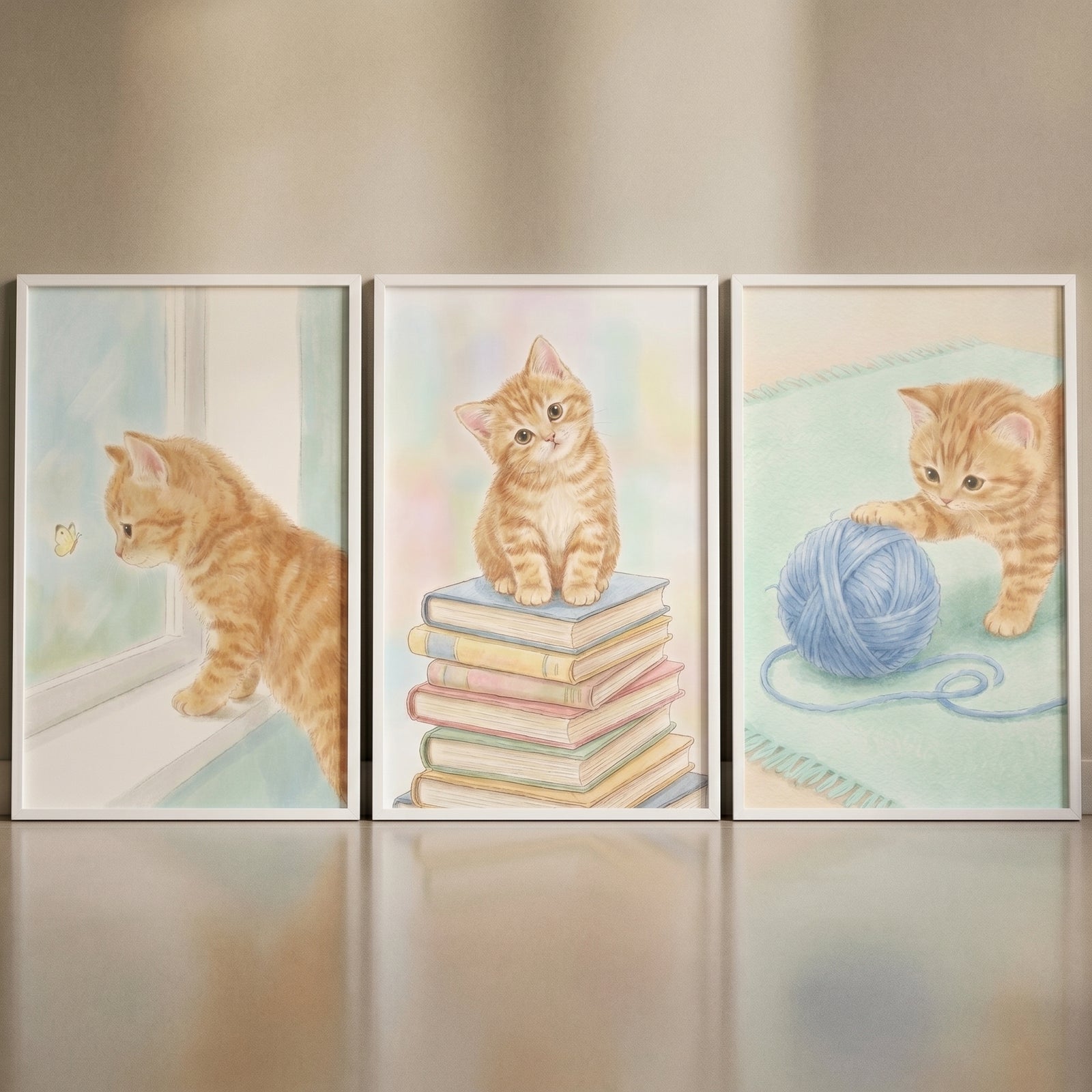 Soft watercolor ginger kitten wall art set of 3 shows a kitten by a window, on books, and with a ball of blue yarn.