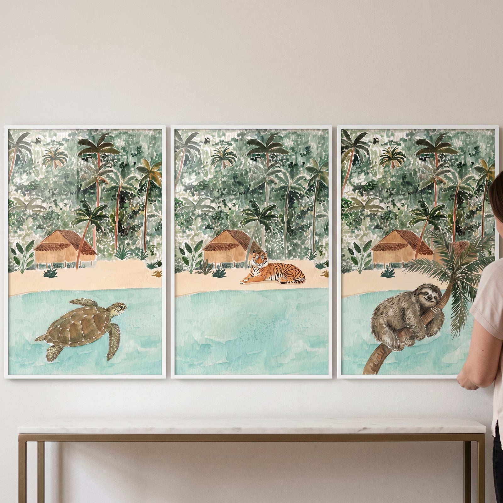Sea turtle, tiger, and sloth tropical scenes. Soft watercolor island animals wall art set of 3 hanging above a table.