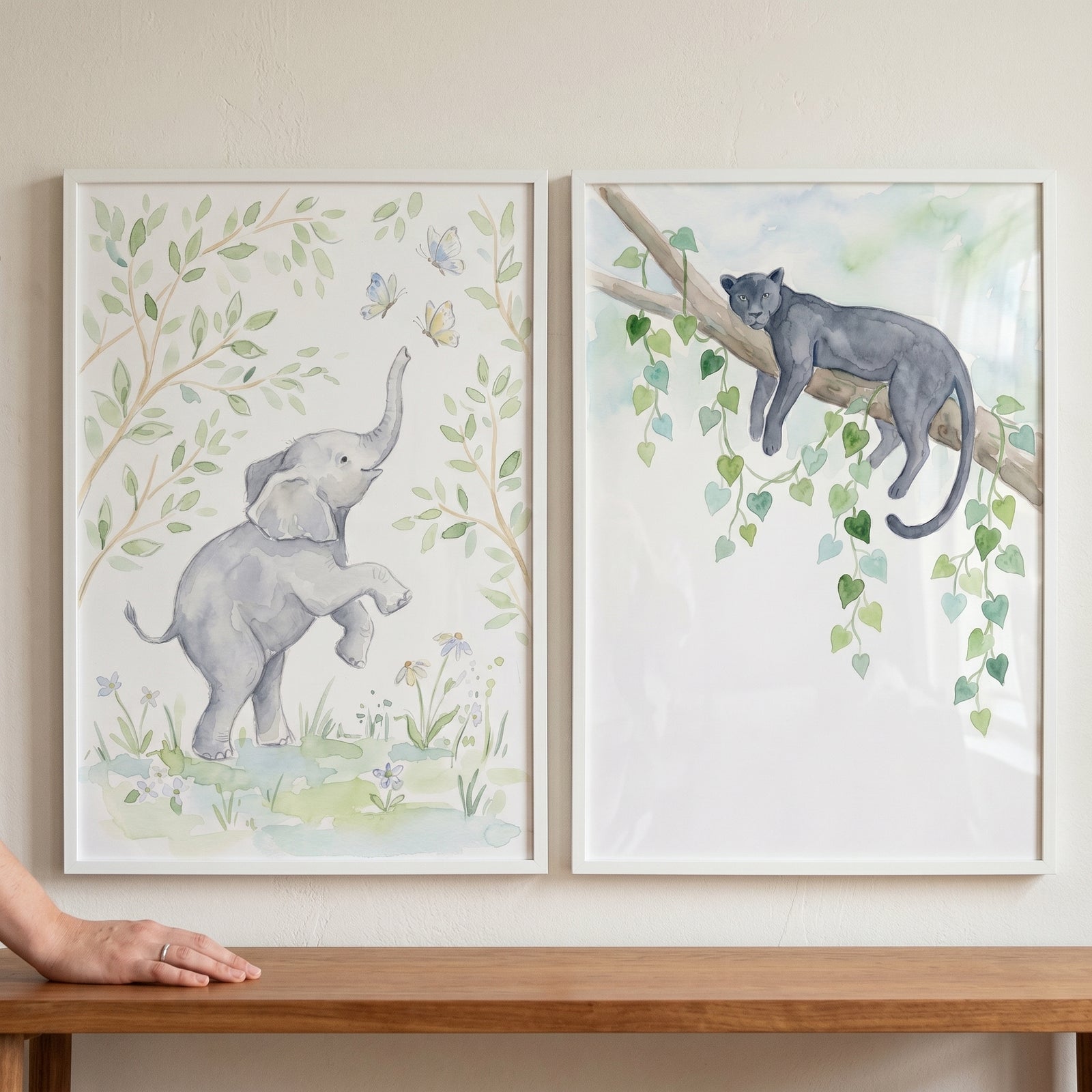 Soft watercolor safari animal wall art set of 2 with a baby elephant reaching for butterflies and a panther on a branch.