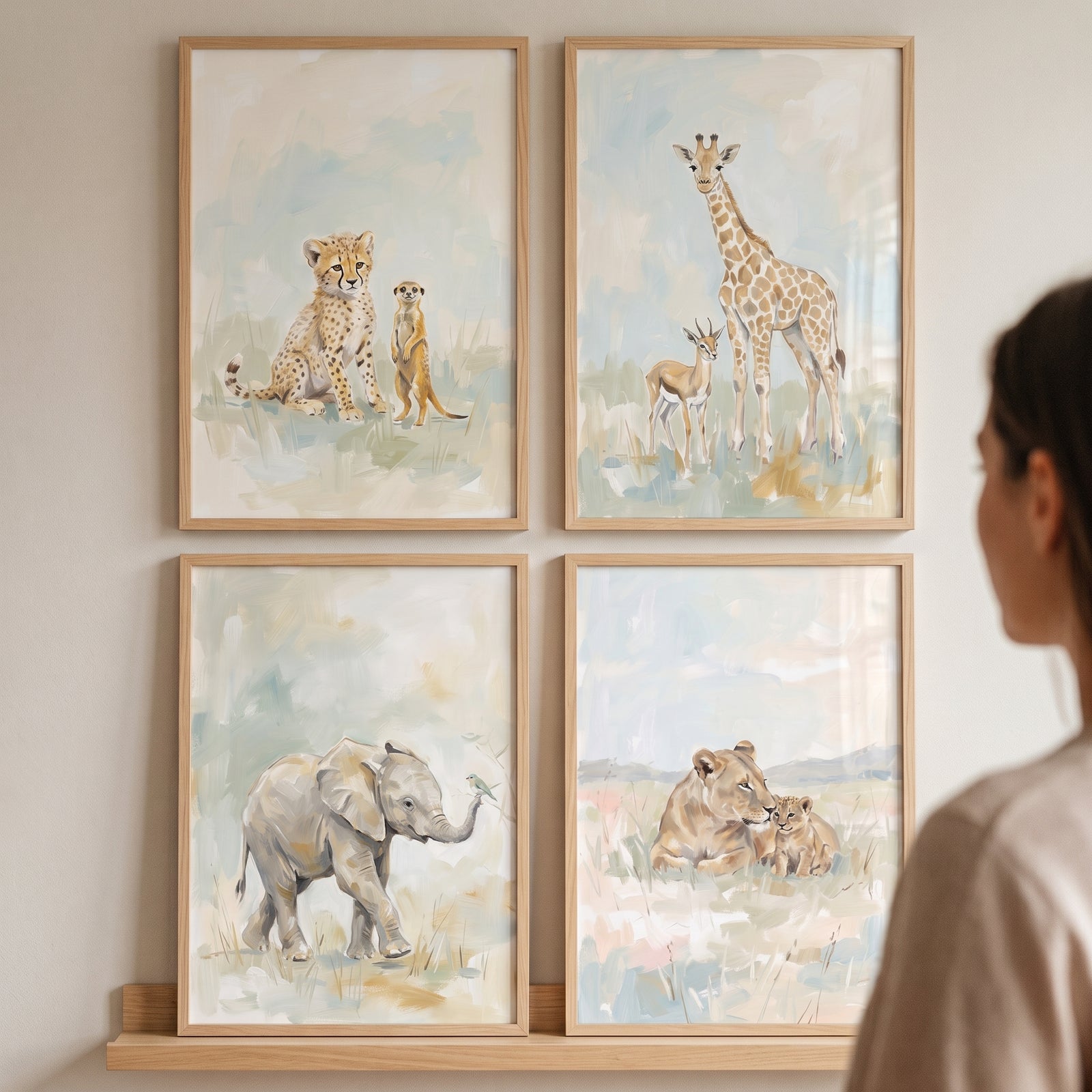 Framed soft watercolor safari animal wall art set of 4 with a cheetah, giraffe, elephant, and lioness with cub.
